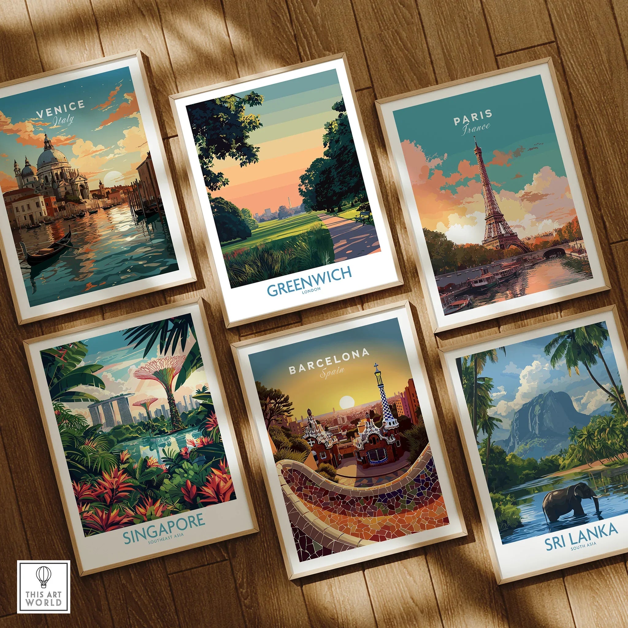 Set of six framed travel posters featuring Venice, Greenwich, Paris, Singapore, Barcelona, and Sri Lanka on a wooden floor.