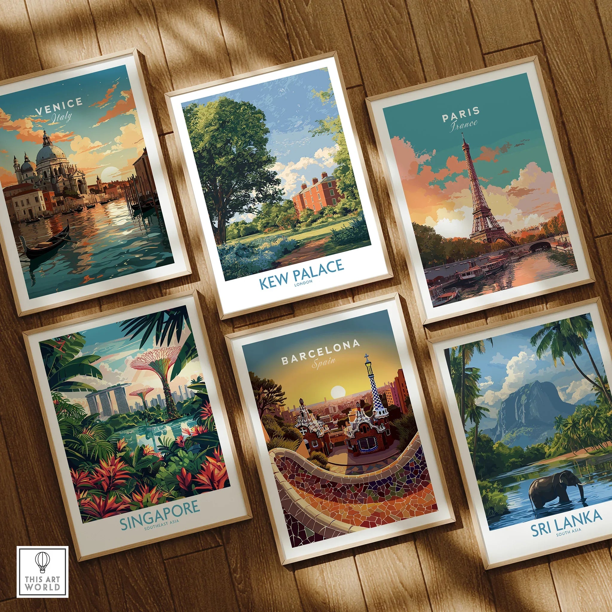 Set of six framed travel posters featuring Venice, Kew Palace, Paris, Singapore, Barcelona, and Sri Lanka on a wooden floor.
