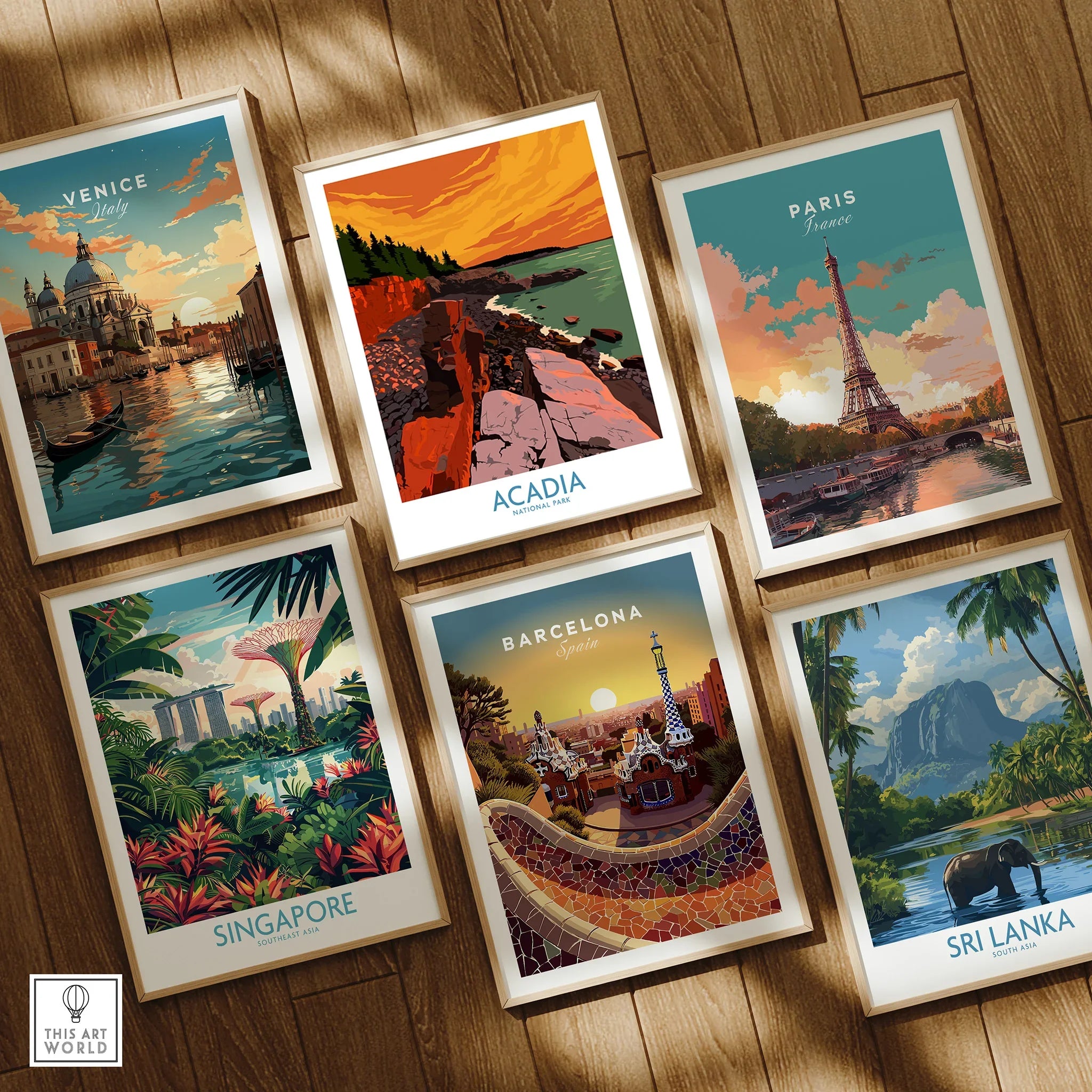 Set of six framed travel posters featuring Venice, Paris, Acadia, Singapore, Barcelona, Sri Lanka on wooden floor.