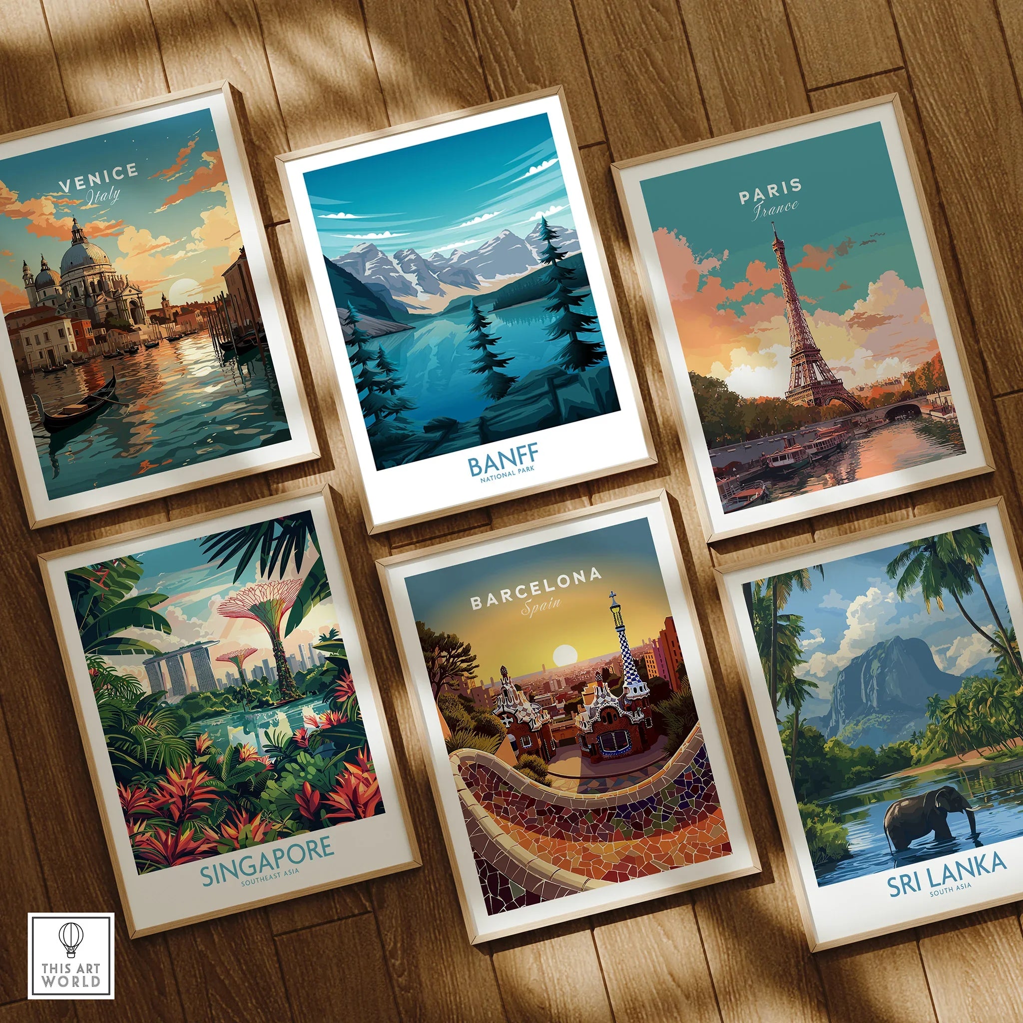 Set of six framed travel art prints featuring Venice, Banff, Paris, Singapore, Barcelona, and Sri Lanka displayed on a wooden floor.