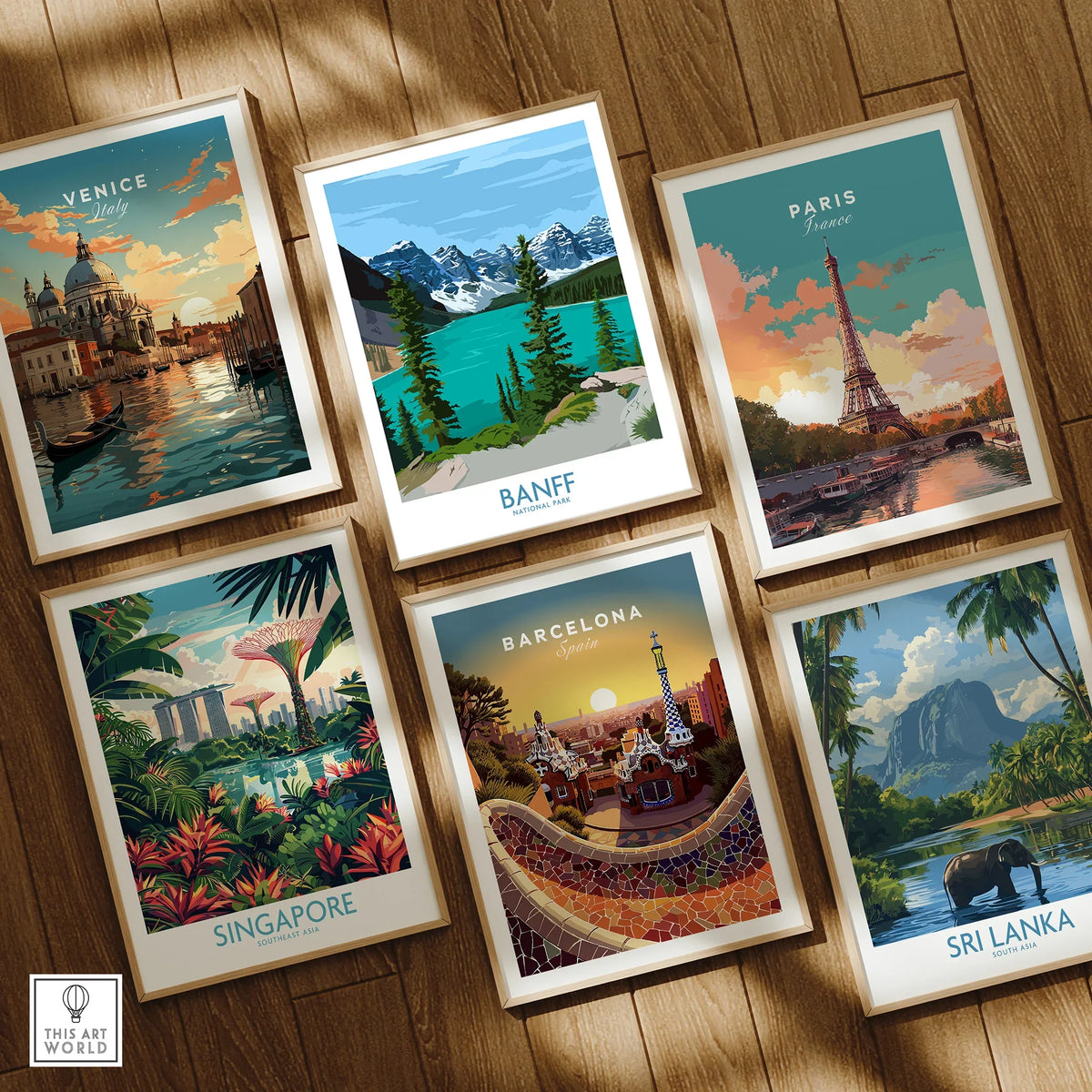 Set of six framed travel art prints featuring Venice, Banff, Paris, Singapore, Barcelona, and Sri Lanka on a wooden floor.