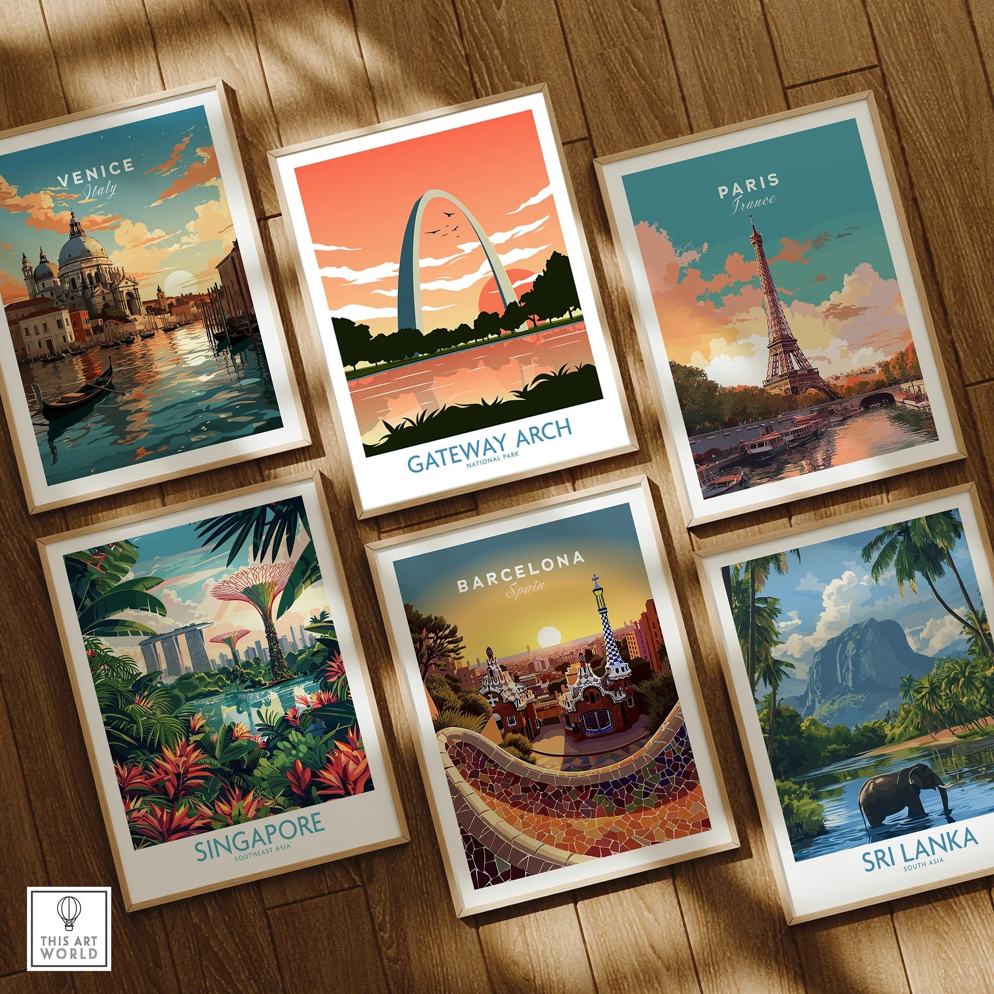 Set of six framed travel art prints featuring Venice, Gateway Arch, Paris, Singapore, Barcelona, and Sri Lanka on a wooden floor.