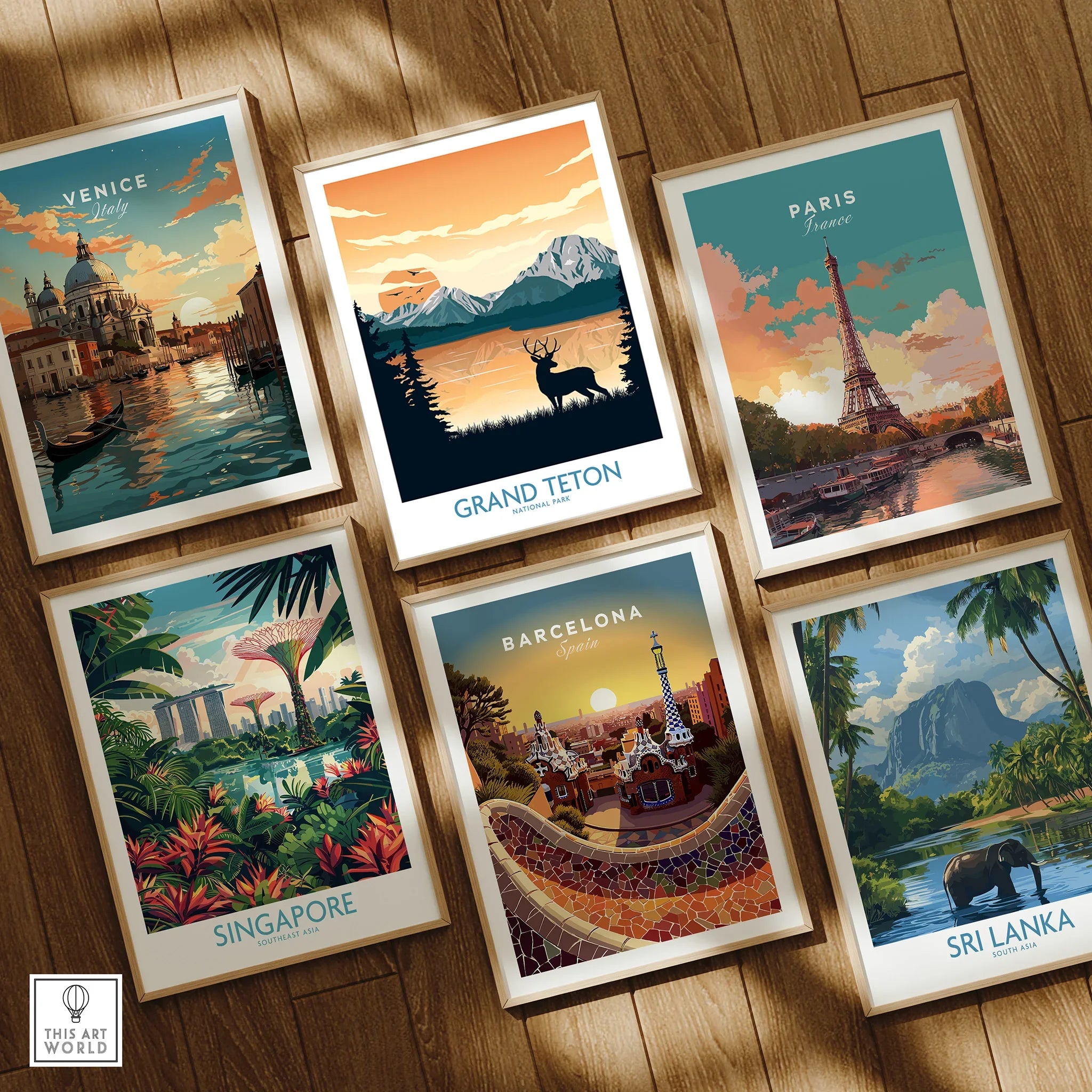 Set of six framed travel art prints featuring Venice, Grand Teton, Paris, Singapore, Barcelona, and Sri Lanka on a wooden floor.