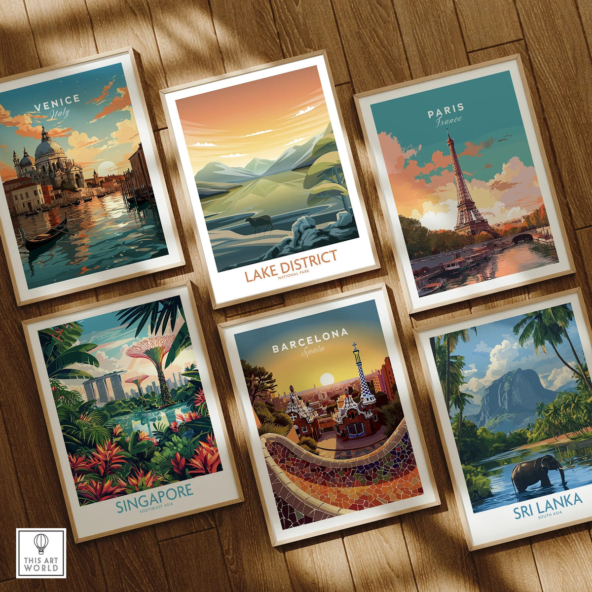 Set of six framed travel art prints featuring Venice, Lake District, Paris, Singapore, Barcelona, and Sri Lanka on a wooden floor
