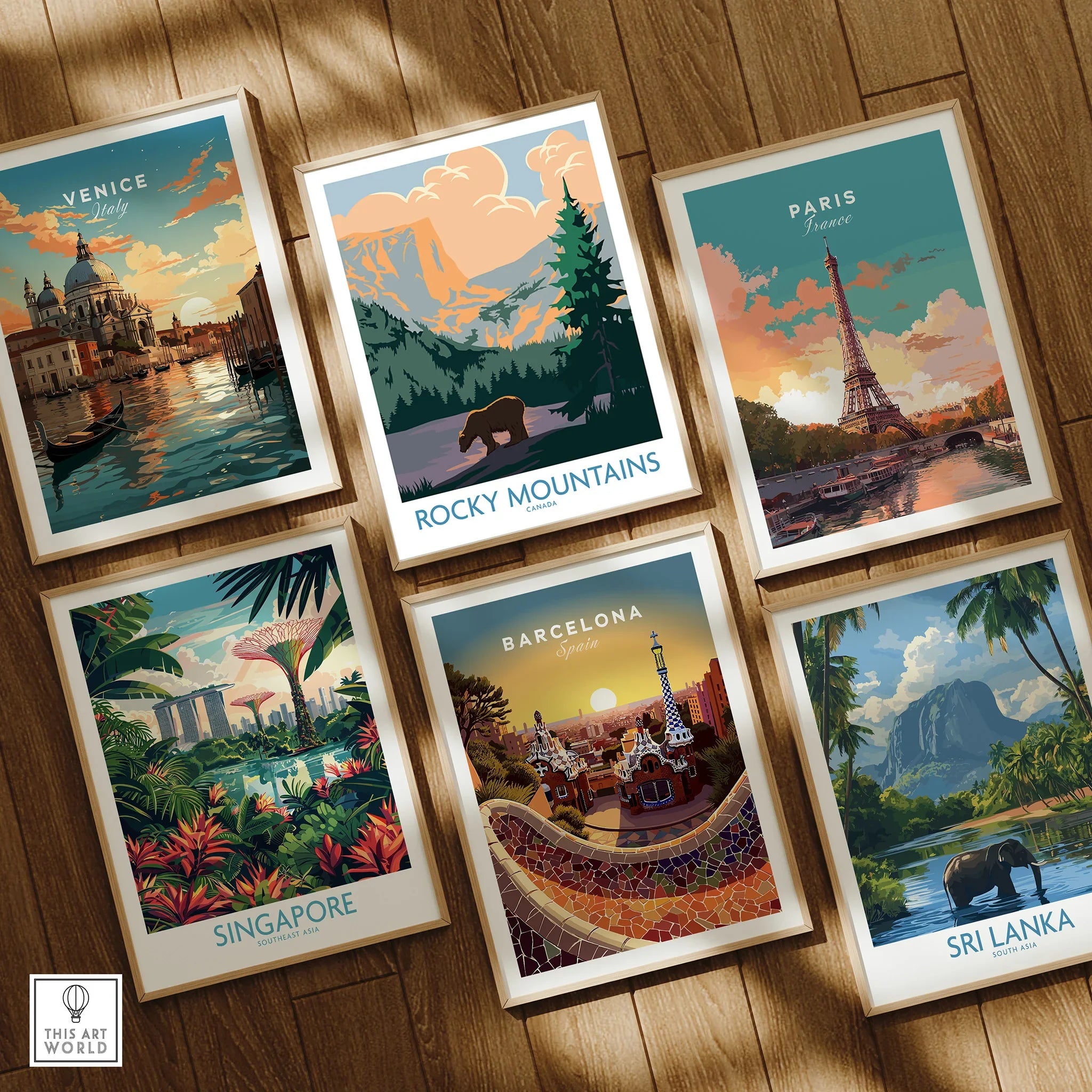 Set of six framed travel art prints featuring Venice, Rocky Mountains, Paris, Singapore, Barcelona, and Sri Lanka on a wooden floor.