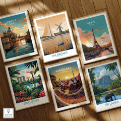 Set of six framed travel posters showing Venice, The Broads, Paris, Singapore, Barcelona, Sri Lanka, on wooden floor.