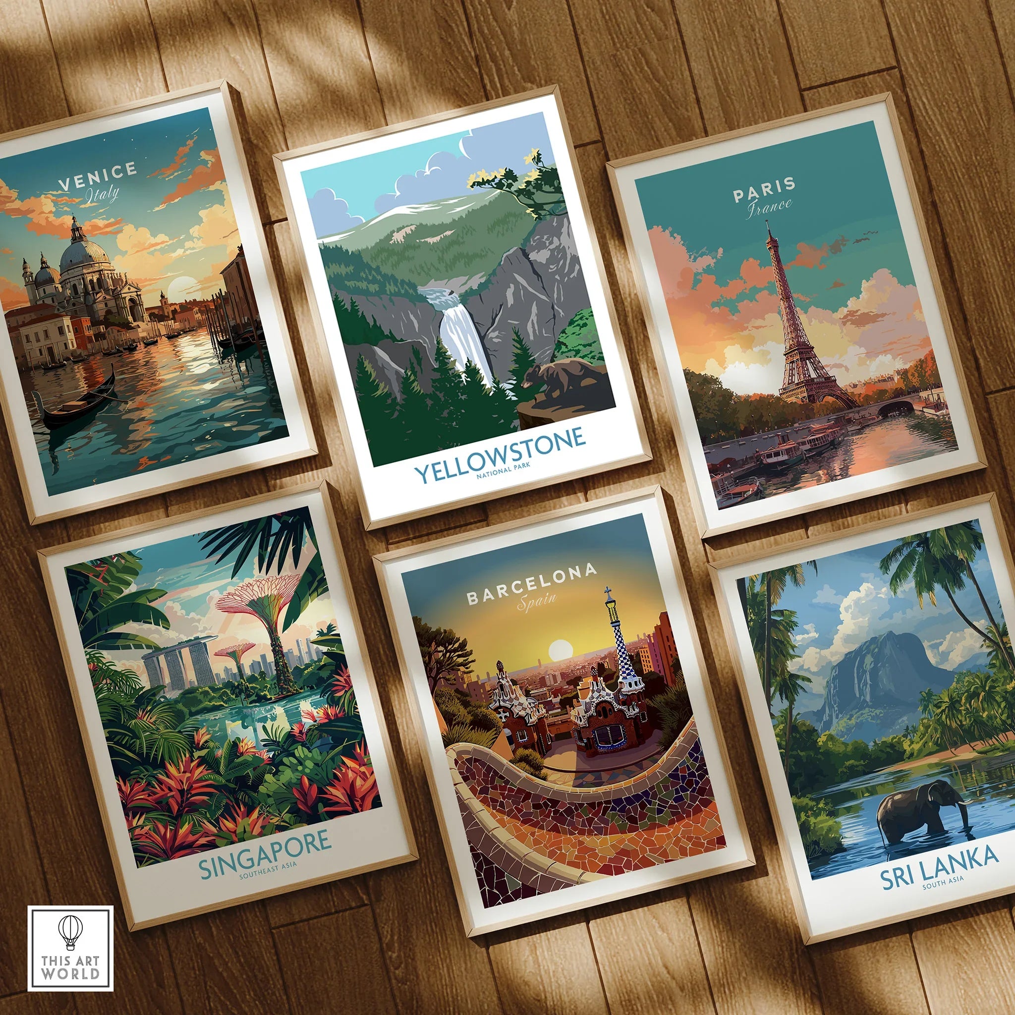 Set of six framed travel art prints featuring Venice, Paris, Yellowstone, Singapore, Barcelona, and Sri Lanka on a wooden floor.