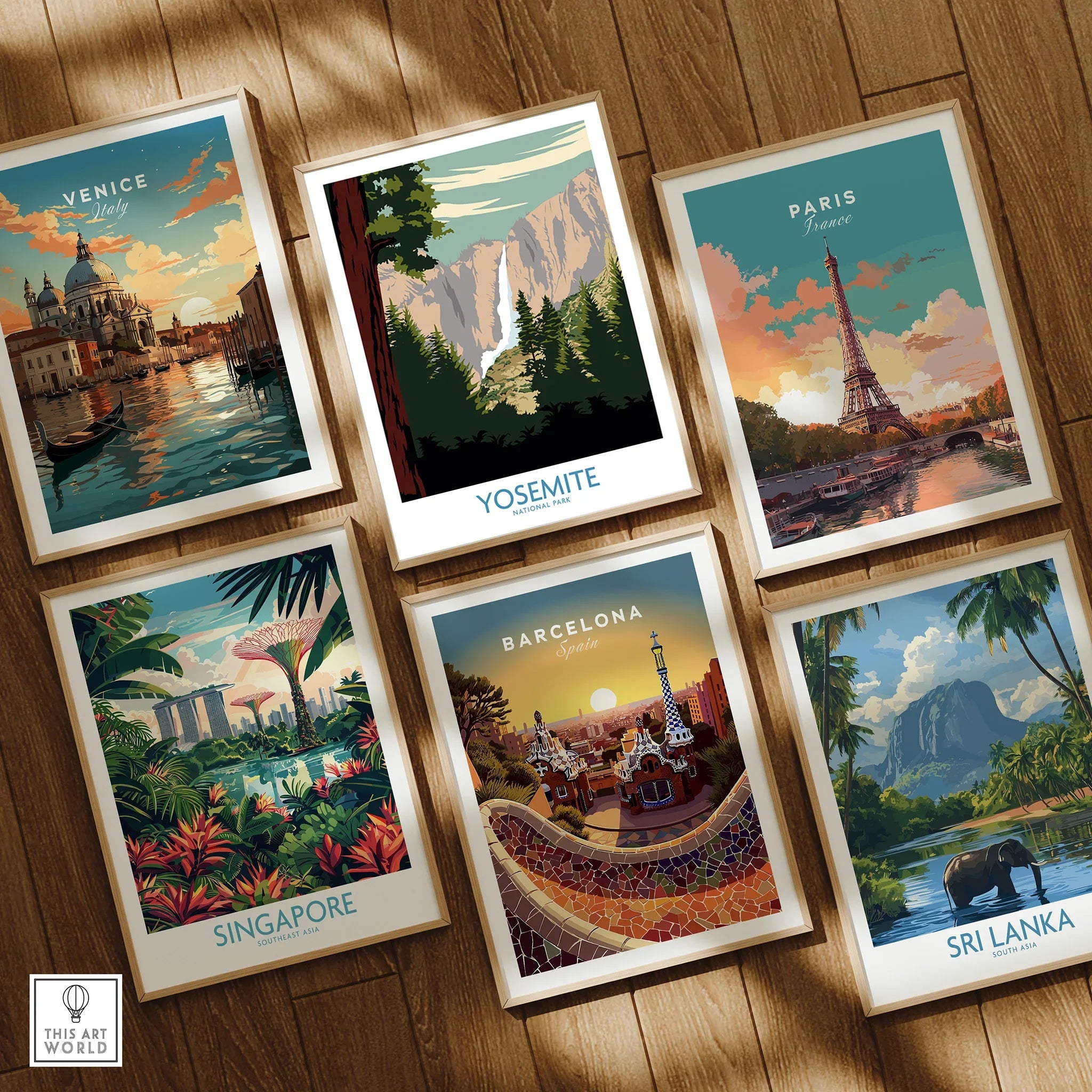 Set of six framed travel and national park art prints on wooden floor, featuring Venice, Yosemite, Paris, Singapore, Barcelona, and Sri Lanka designs.