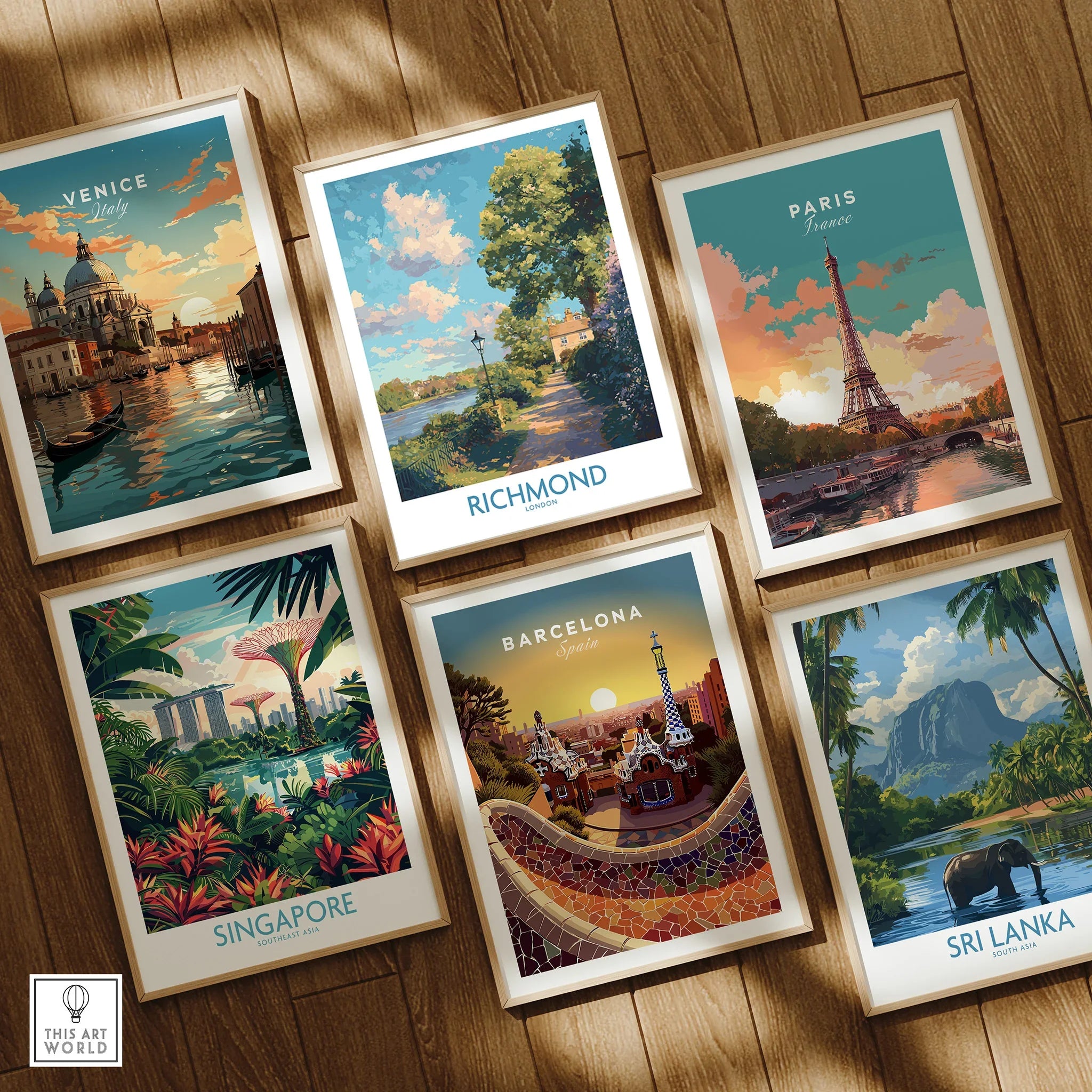 Set of six framed travel poster prints on wooden floor, featuring iconic city and nature scenes from Venice, Richmond, Paris, Singapore, Barcelona, and Sri Lanka.