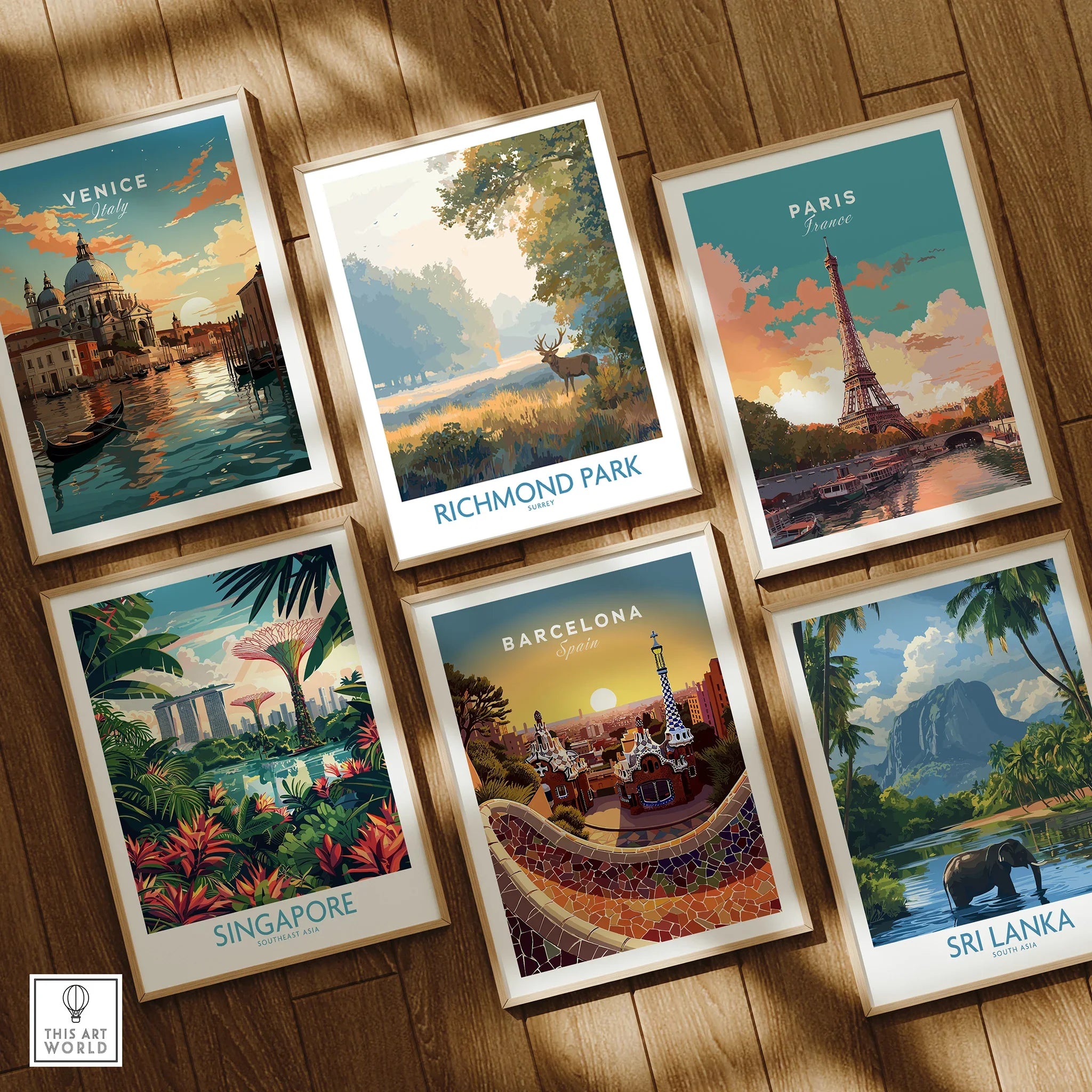 Set of six framed travel posters featuring Venice, Richmond Park, Paris, Singapore, Barcelona, and Sri Lanka on a wooden floor.