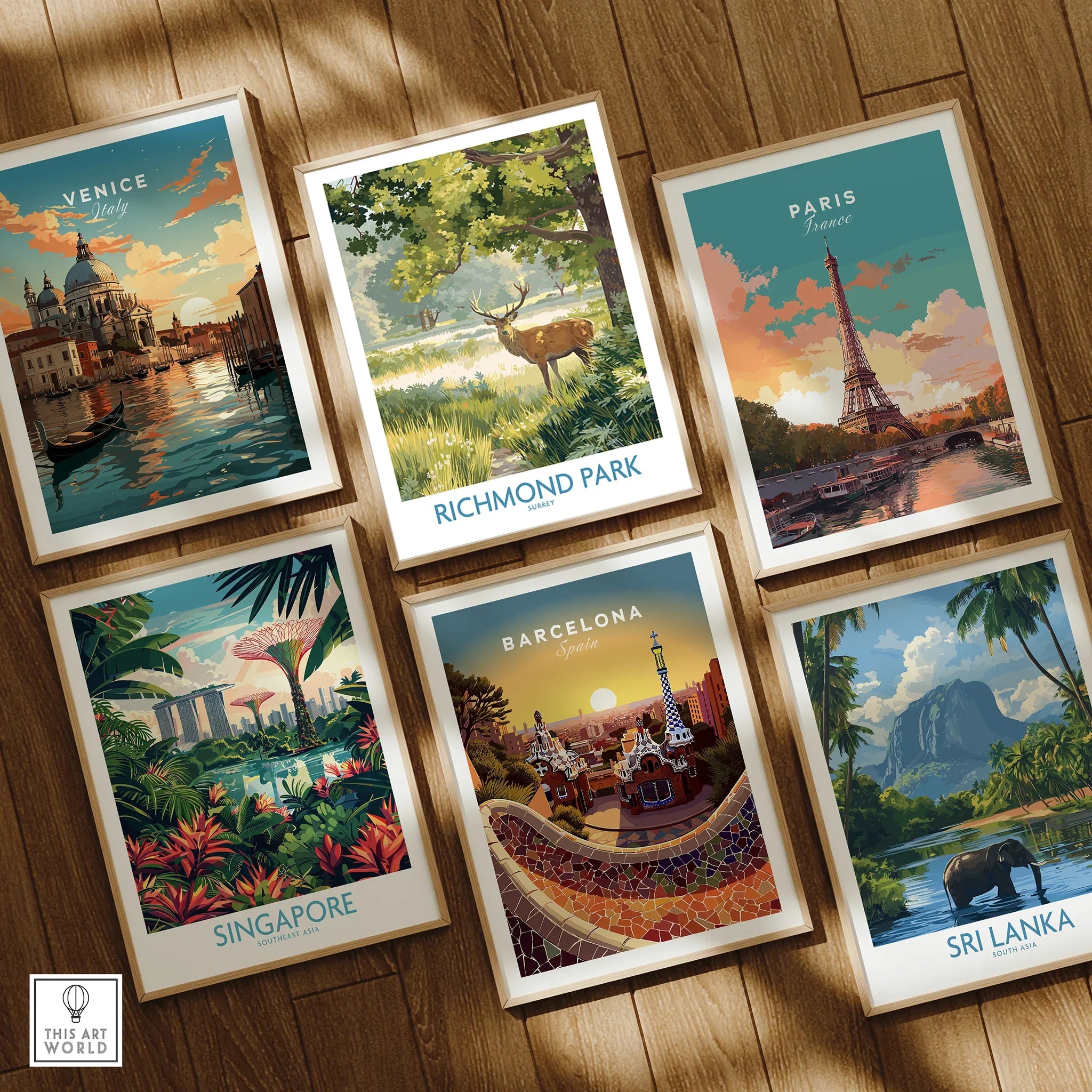Set of six framed travel posters featuring Venice, Paris, Singapore, Barcelona, Sri Lanka, and Richmond Park on a wooden floor.