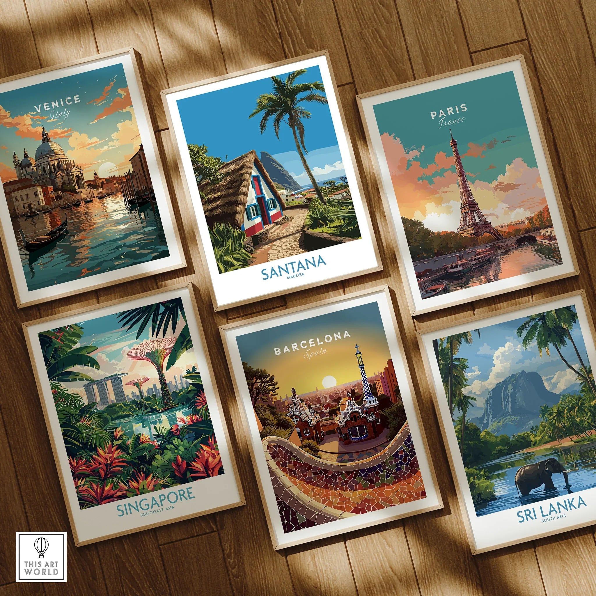 Set of six framed travel art prints featuring Venice, Paris, Singapore, Santana, Barcelona, and Sri Lanka on a wooden floor.