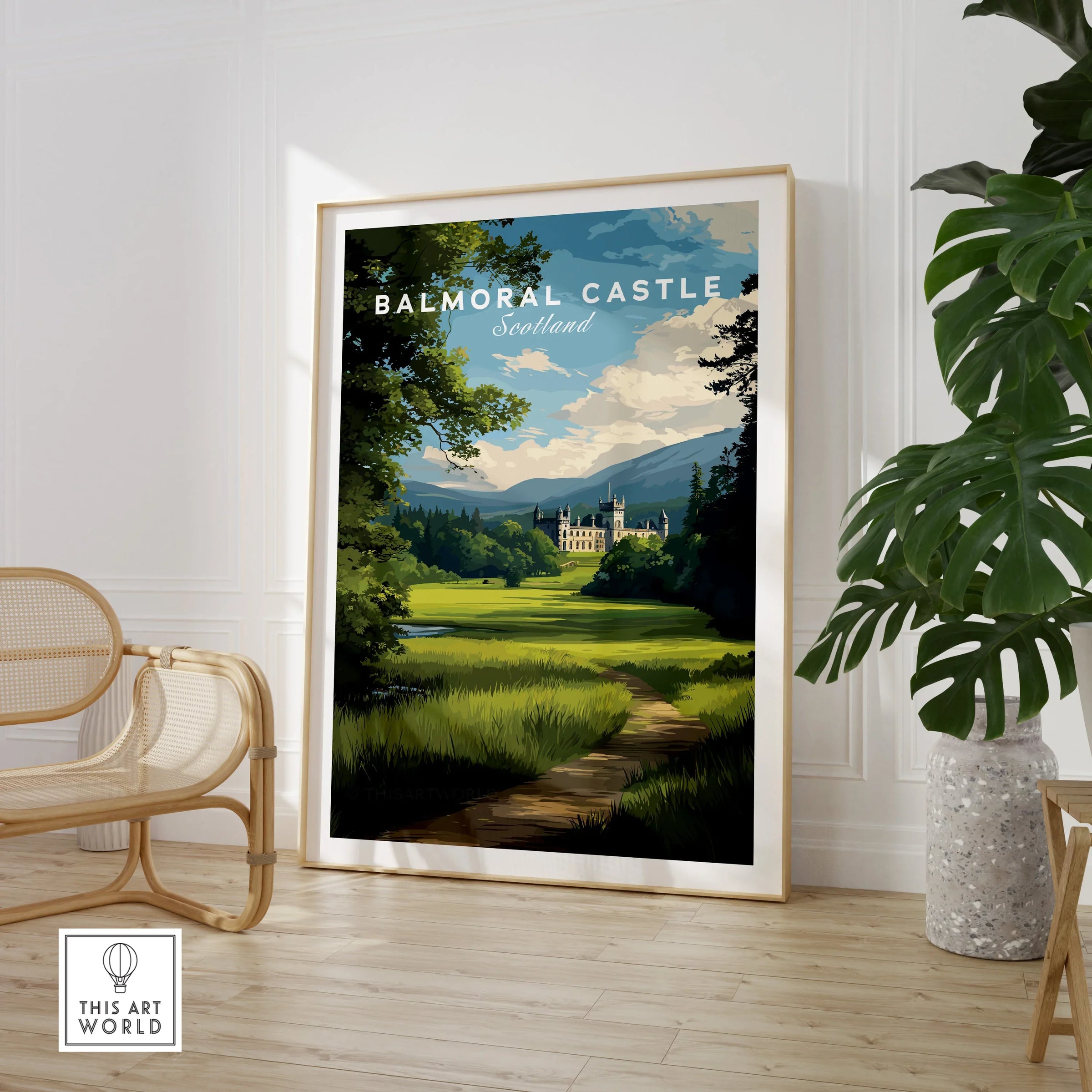 Framed Balmoral Castle travel poster in stylish room with chair and potted plant