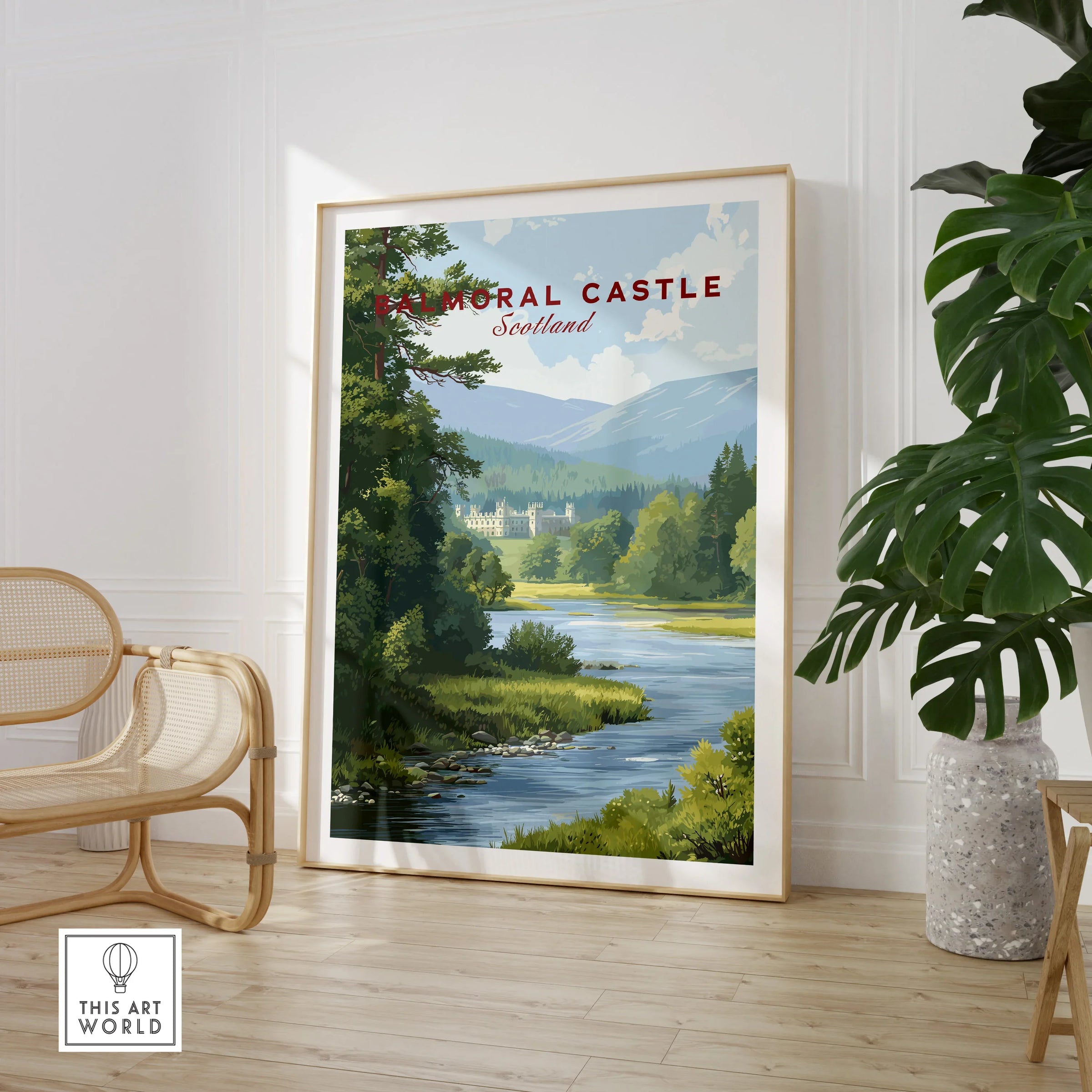 Balmoral Castle Scotland travel poster print in frame, stylishly displayed in modern room with plant and chair