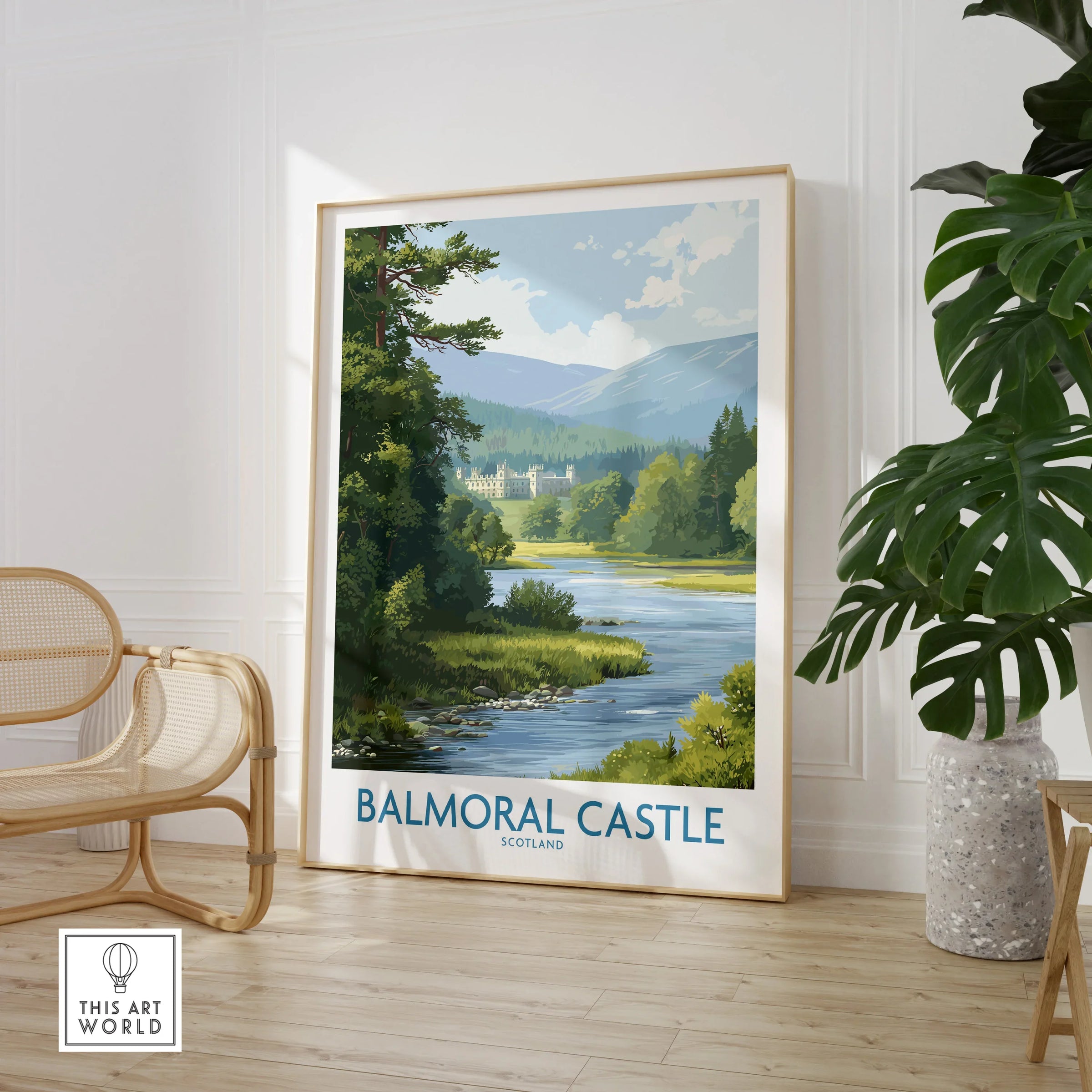 Framed Balmoral Castle travel art print in a modern room with chair and potted plant