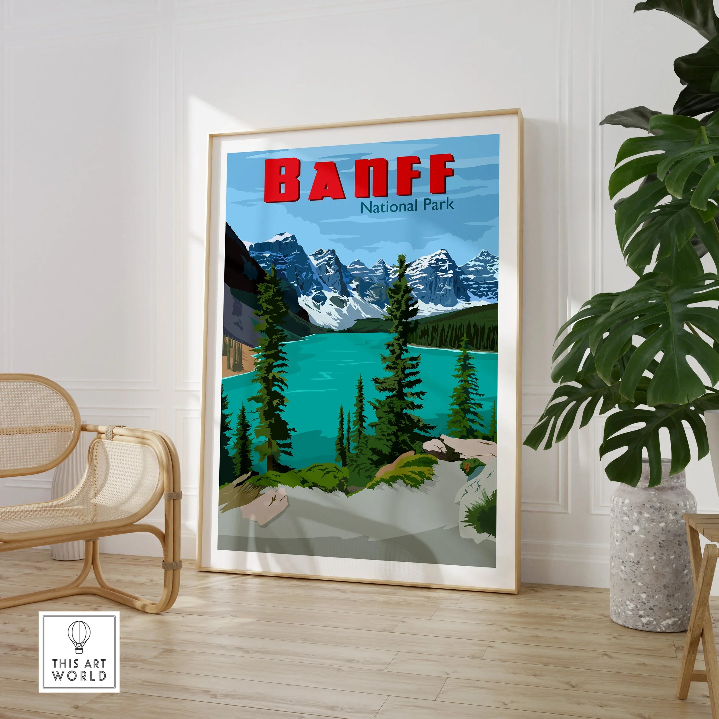 Banff National Park travel poster framed and displayed in a modern room with chair and plant