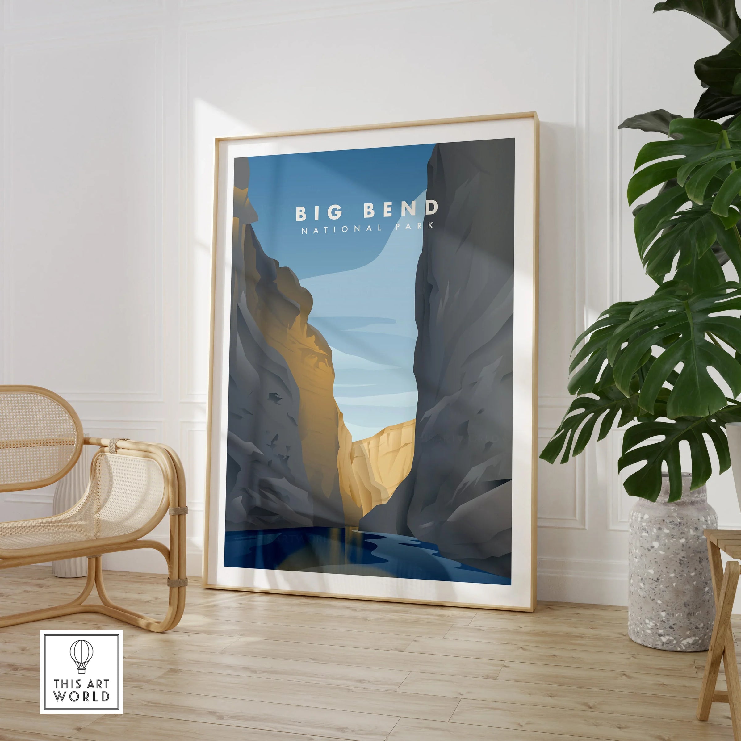 Framed Big Bend National Park travel poster art in modern living room with chair and plant