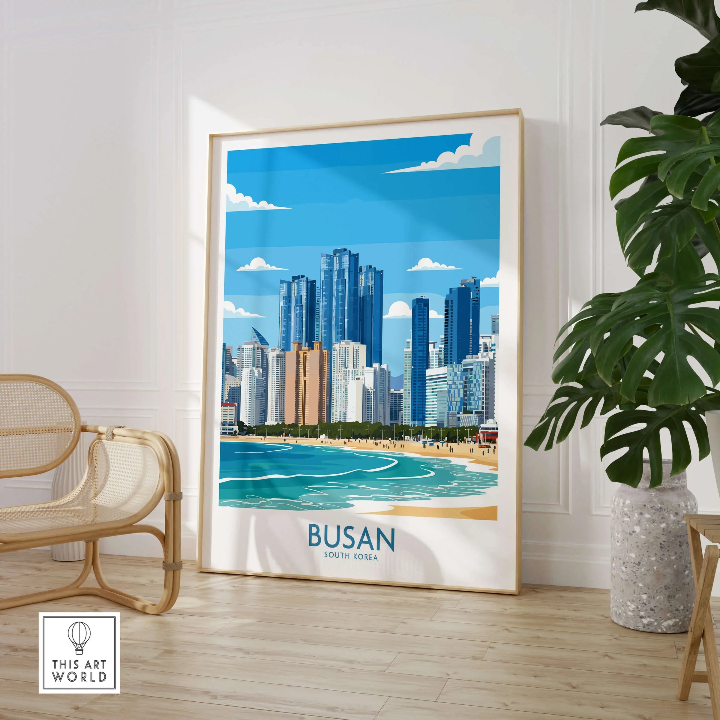 Framed Busan South Korea city skyline art print in modern room with chair and plant