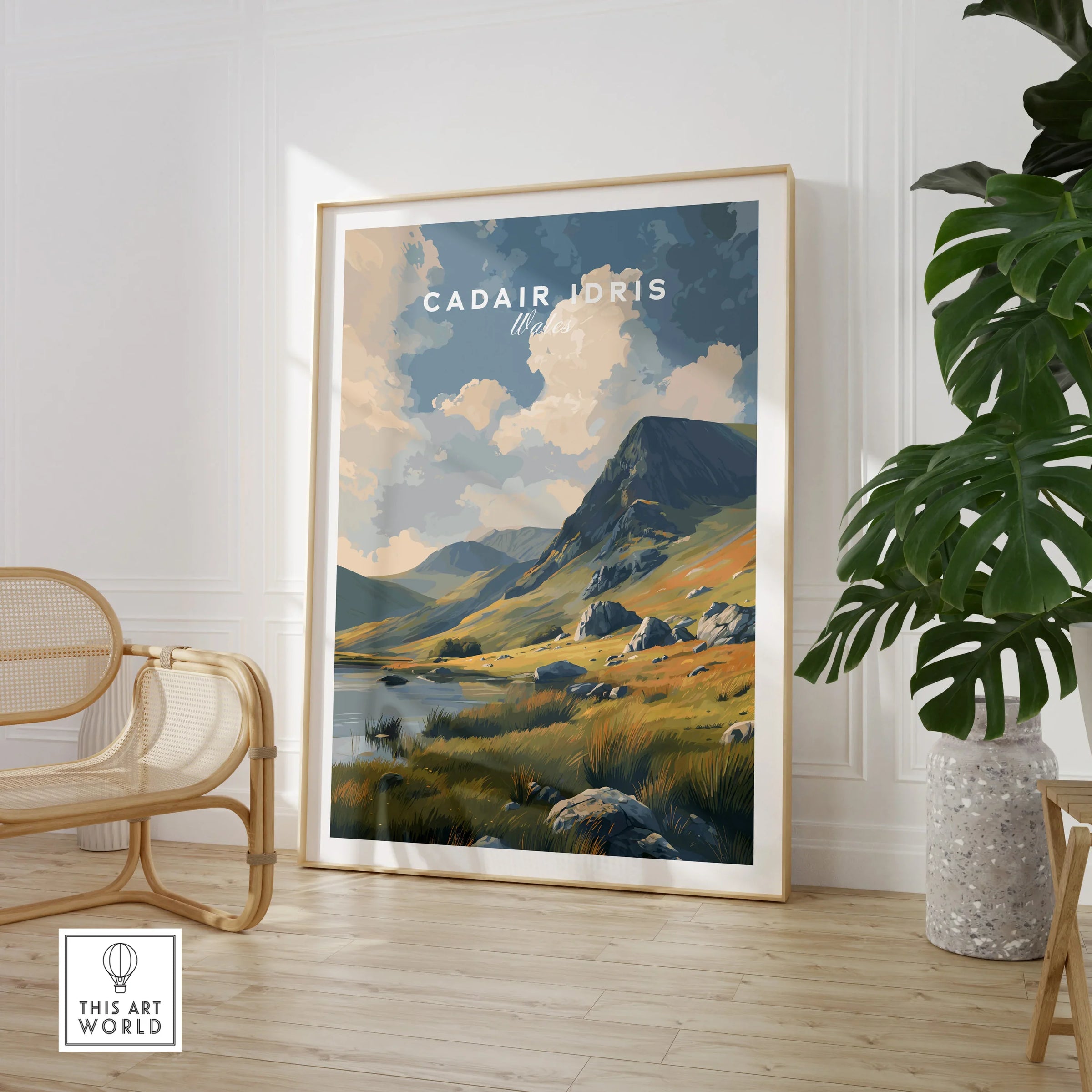 Framed Cadair Idris Wales travel poster in modern living room with chair and plant.