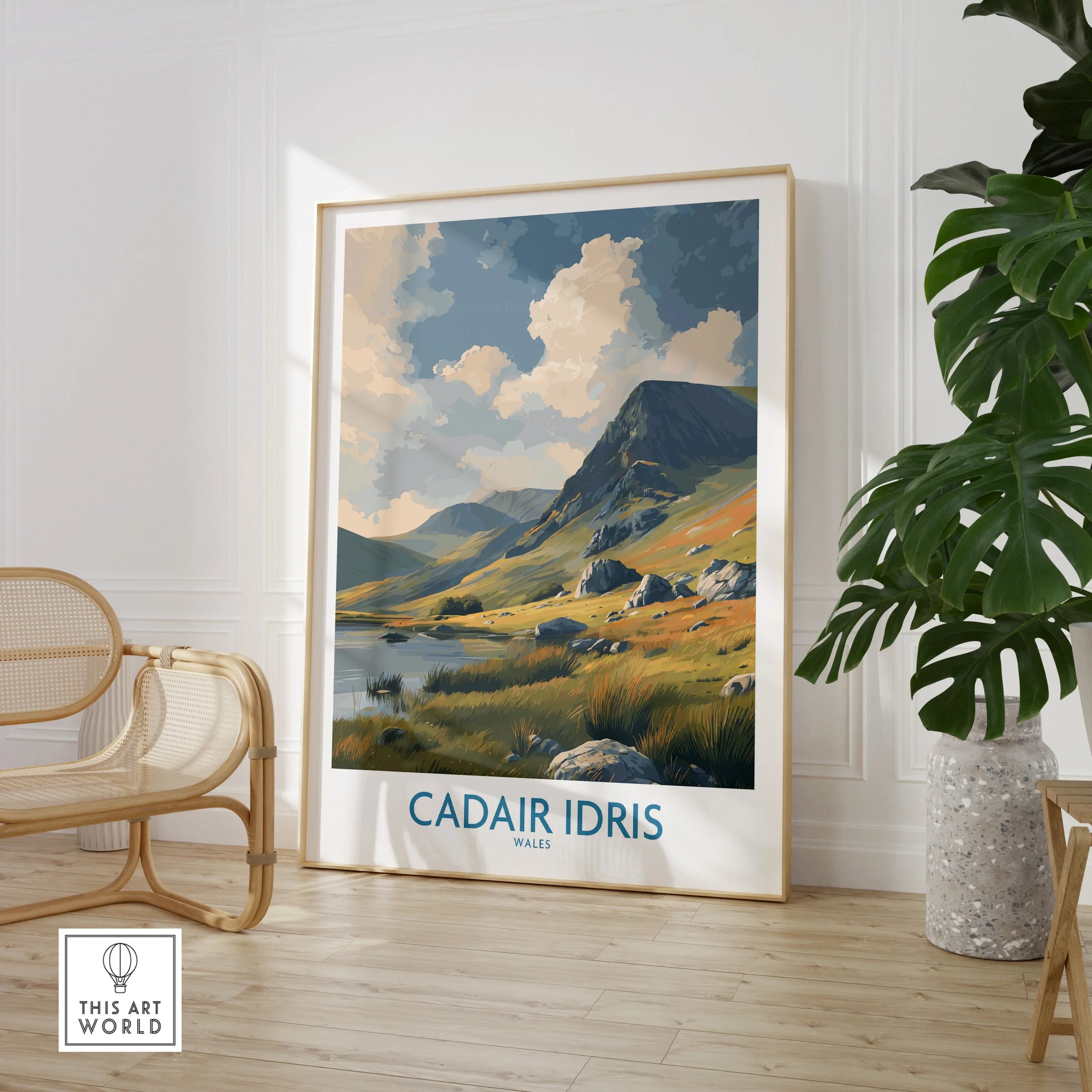 Framed Cadair Idris Wales travel poster in modern room with plant and chair