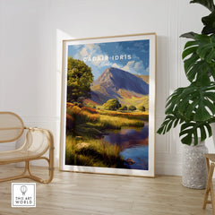 Framed Cadair Idris Wales travel poster print in modern room with chair and plant