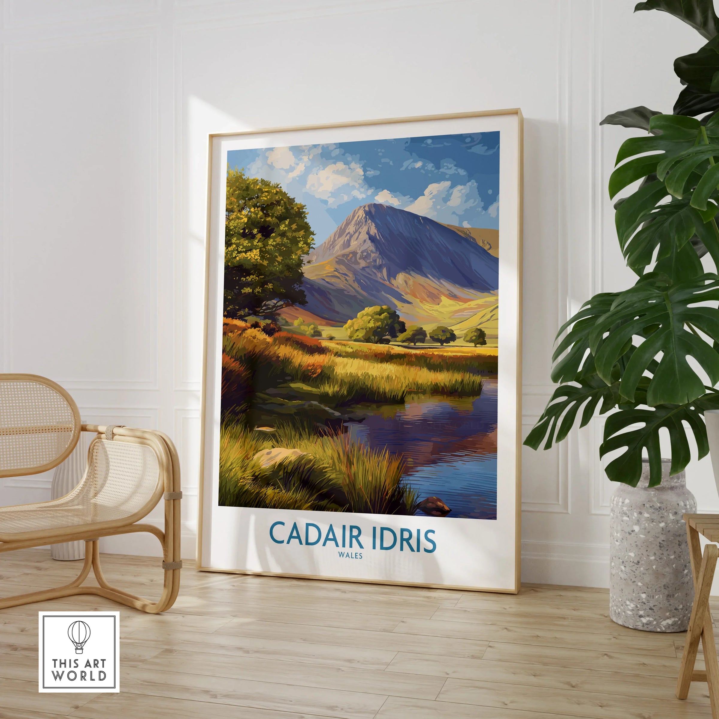 Framed Cadair Idris travel poster print in modern room with chair and plant, mountain landscape art