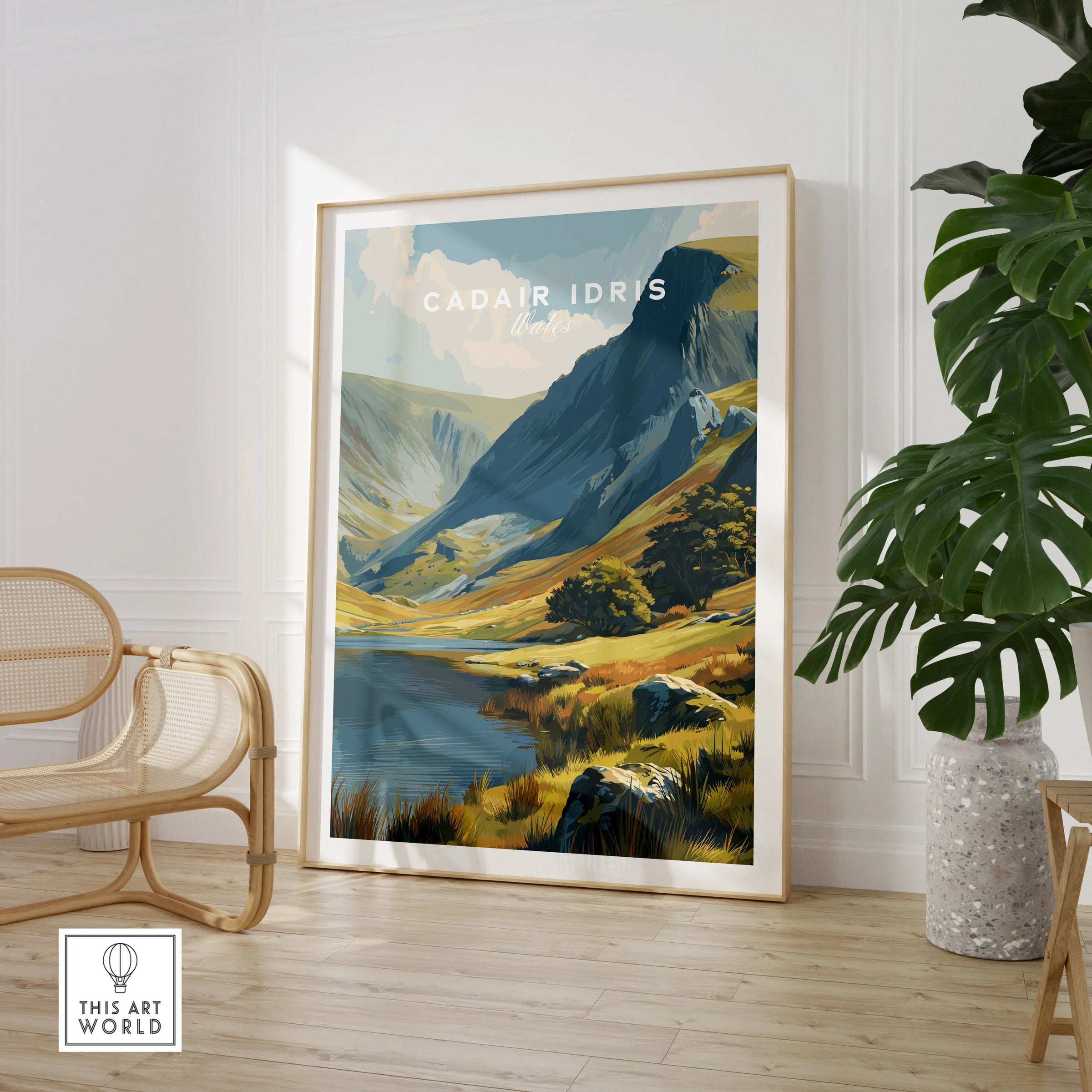Framed Cadair Idris Wales travel poster in modern room with chair and houseplant