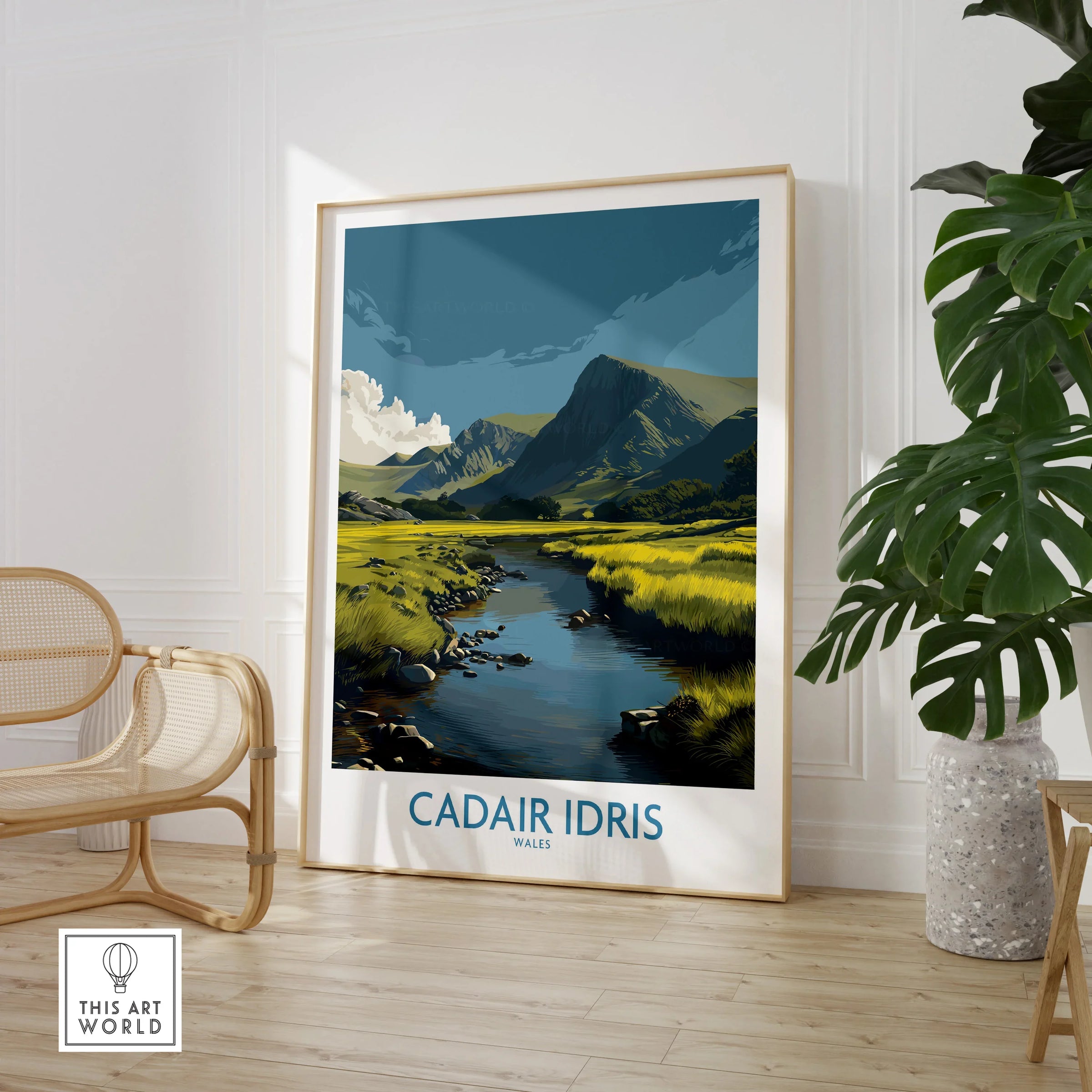 Framed Cadair Idris Wales travel poster in a modern room with chair and plant