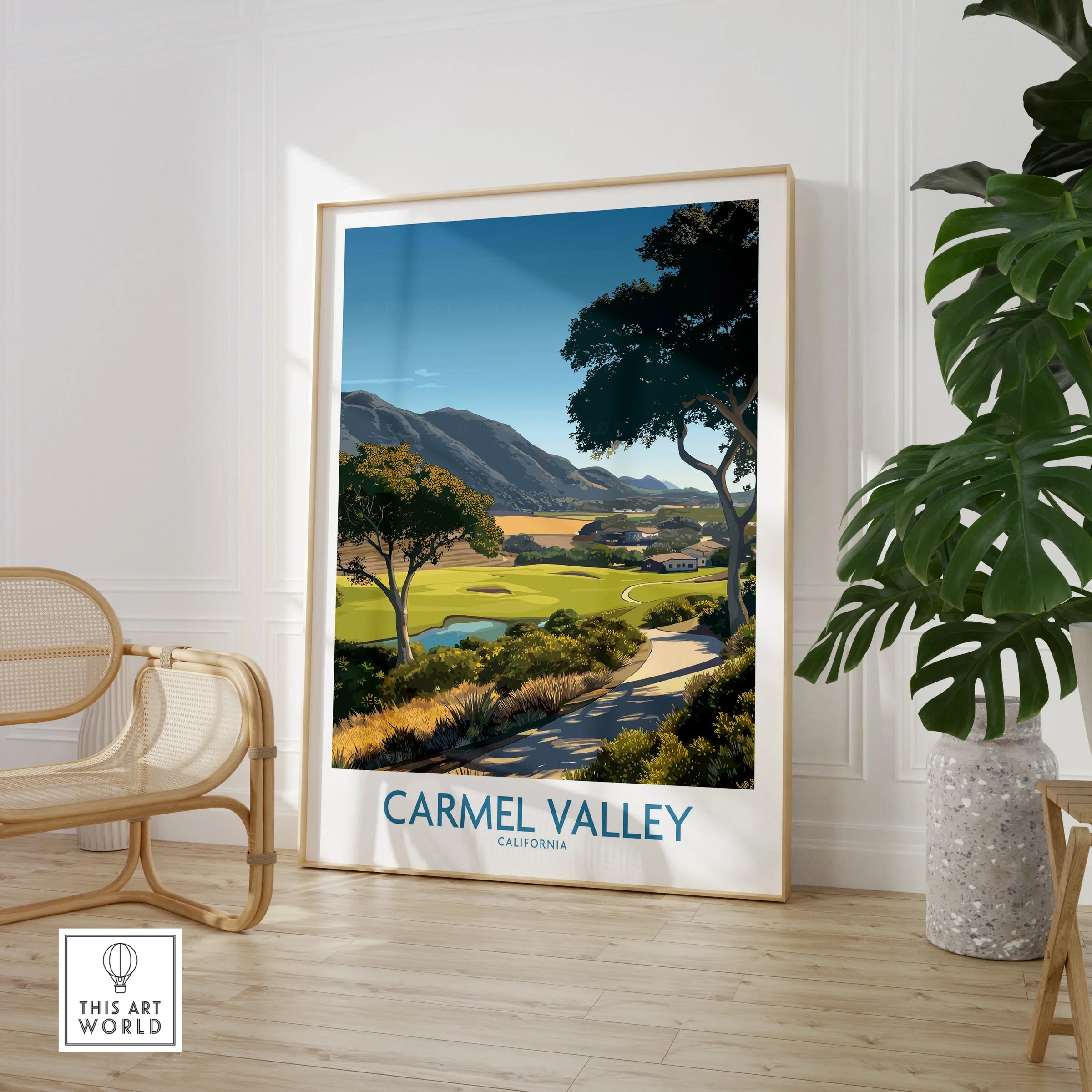 Framed Carmel Valley California travel poster in modern room with chair and houseplant