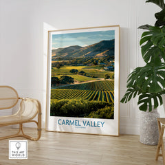 Framed Carmel Valley California travel poster in modern room with chair and green plant