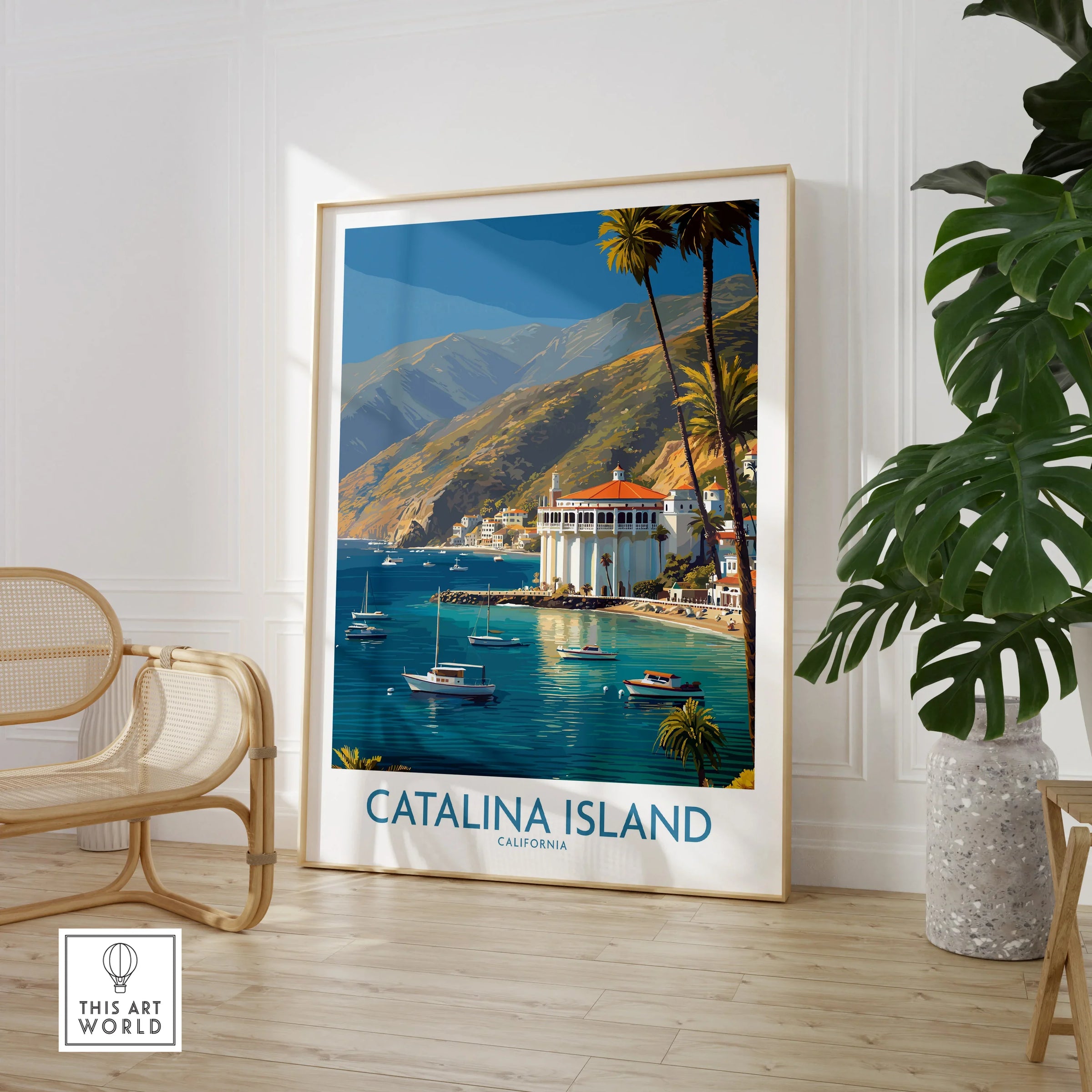Catalina Island travel poster framed on wall near rattan chair and large green plant