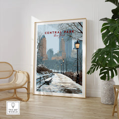 Framed Central Park New York winter art print in modern room with chair and plant