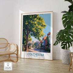 Colchester England travel poster framed on floor in modern room with chair and plant