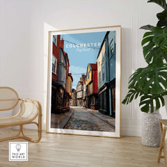 Colchester England travel poster framed print in modern room with chair and plant