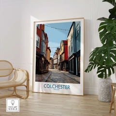 Colchester England travel poster framed, displayed in modern room with chair and plant