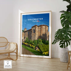 Framed Colchester England travel poster print in modern room with plant and chair