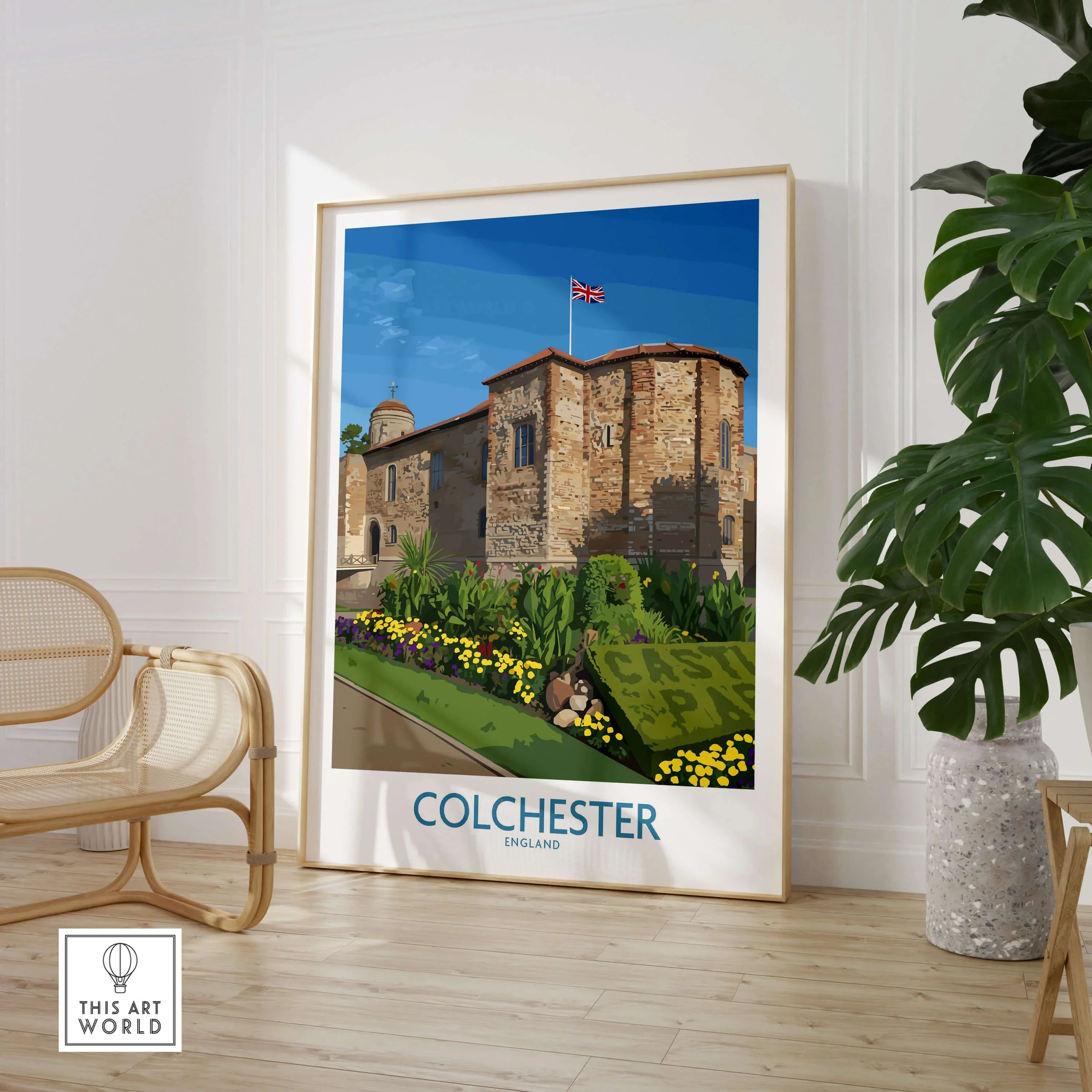 Colchester travel poster framed in modern room with rattan chair and potted plant