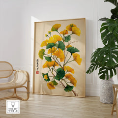Framed ginkgo leaf botanical art print in modern room with chair and green plant