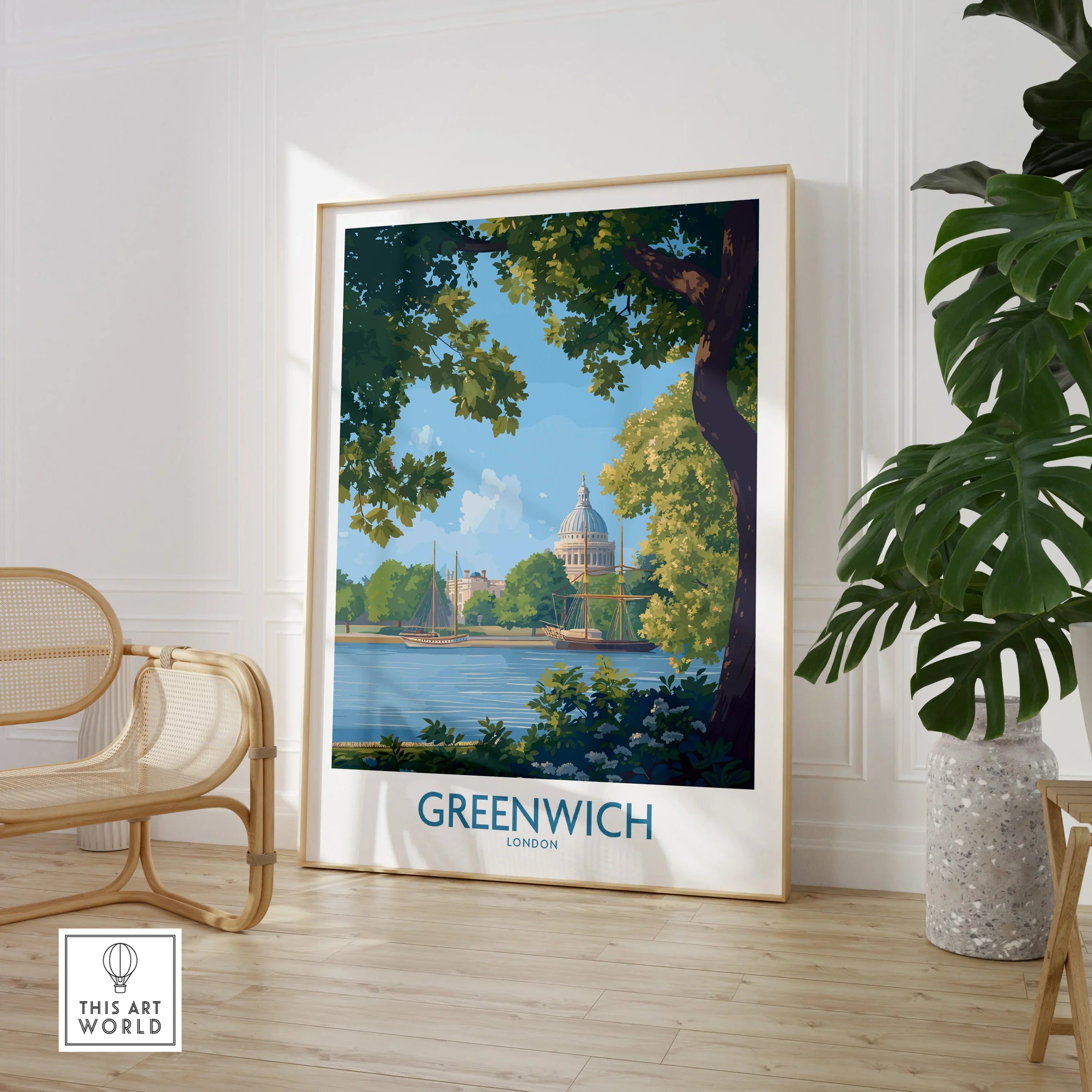 Framed Greenwich London travel poster in modern room with rattan chair and leafy plant.