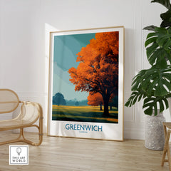 Framed Greenwich London travel poster with autumn tree, displayed in modern living room decor.