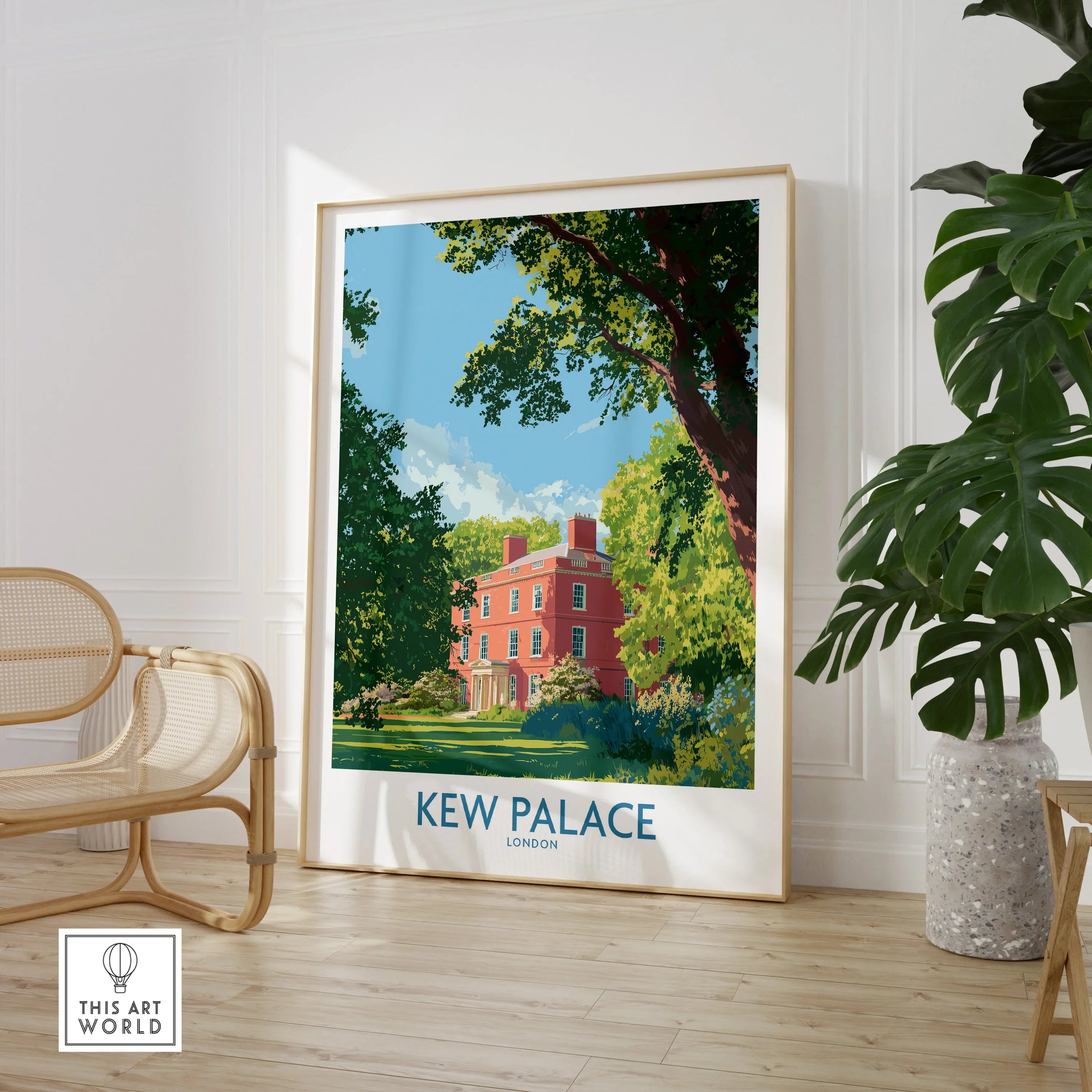 Framed Kew Palace London art print in a modern room with a chair and green plant