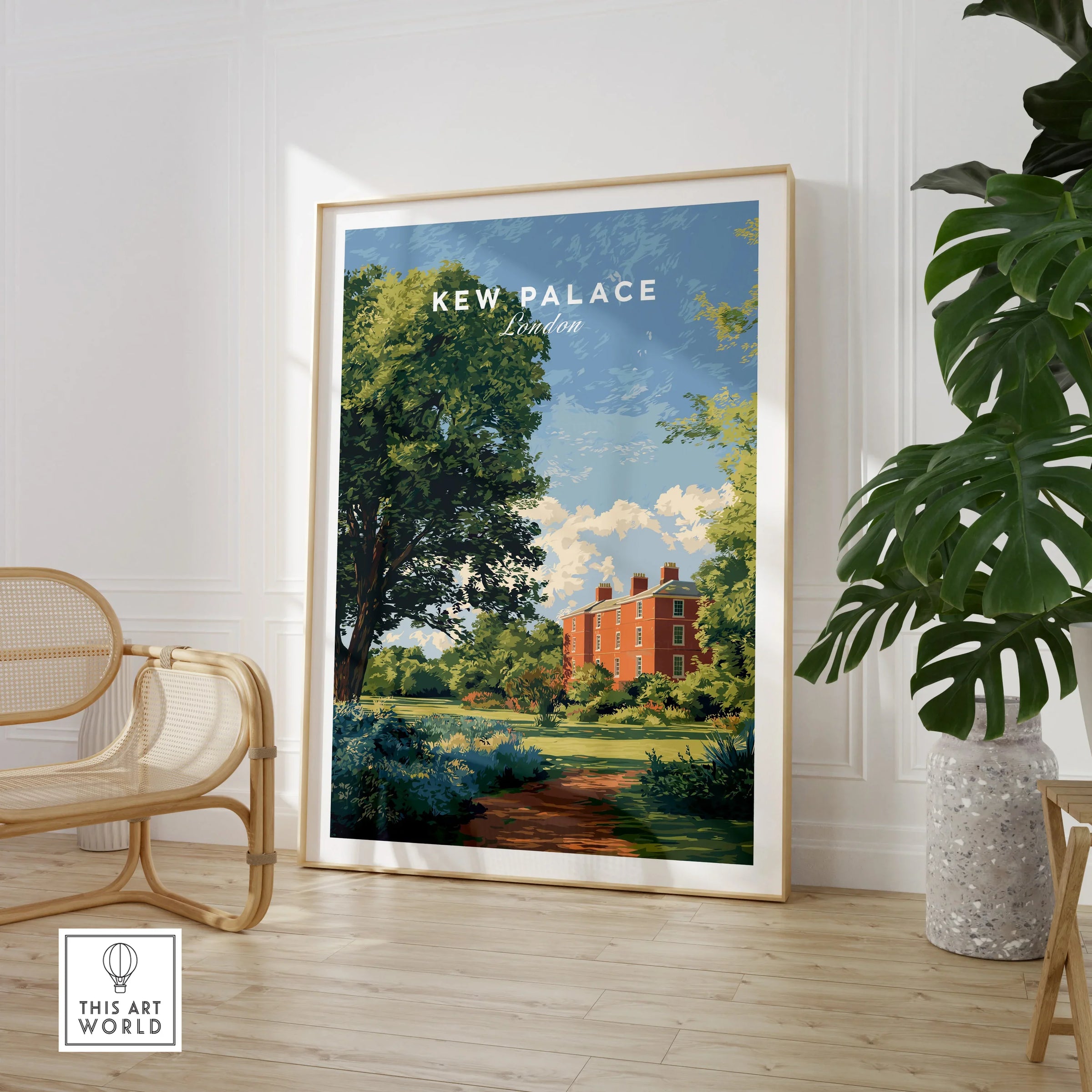 Framed Kew Palace London travel poster in modern living room with chair and plant.