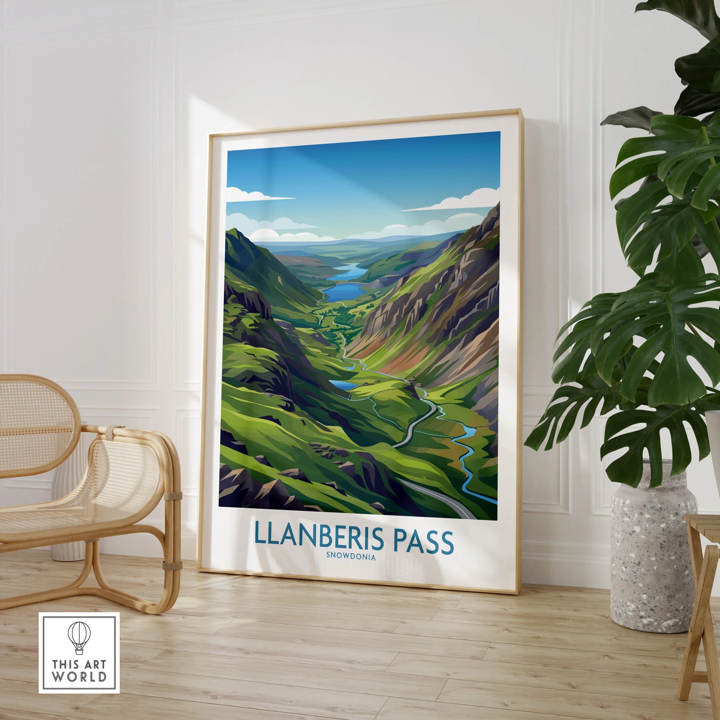 Framed Llanberis Pass Snowdonia landscape print in modern room with chair and plant