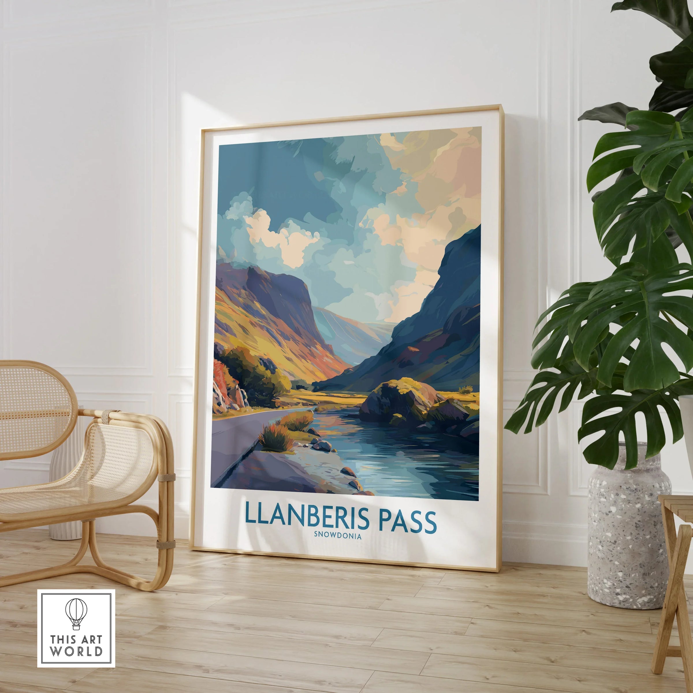 Llanberis Pass framed travel poster in modern room with chair and green plant
