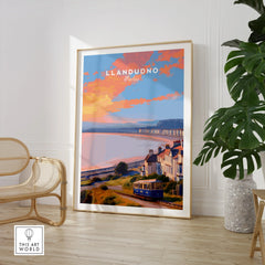 Framed Llandudno Wales travel poster in modern room with chair and plant