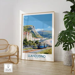 Framed Llandudno travel poster with vintage tram and coastal scenery in modern living room.