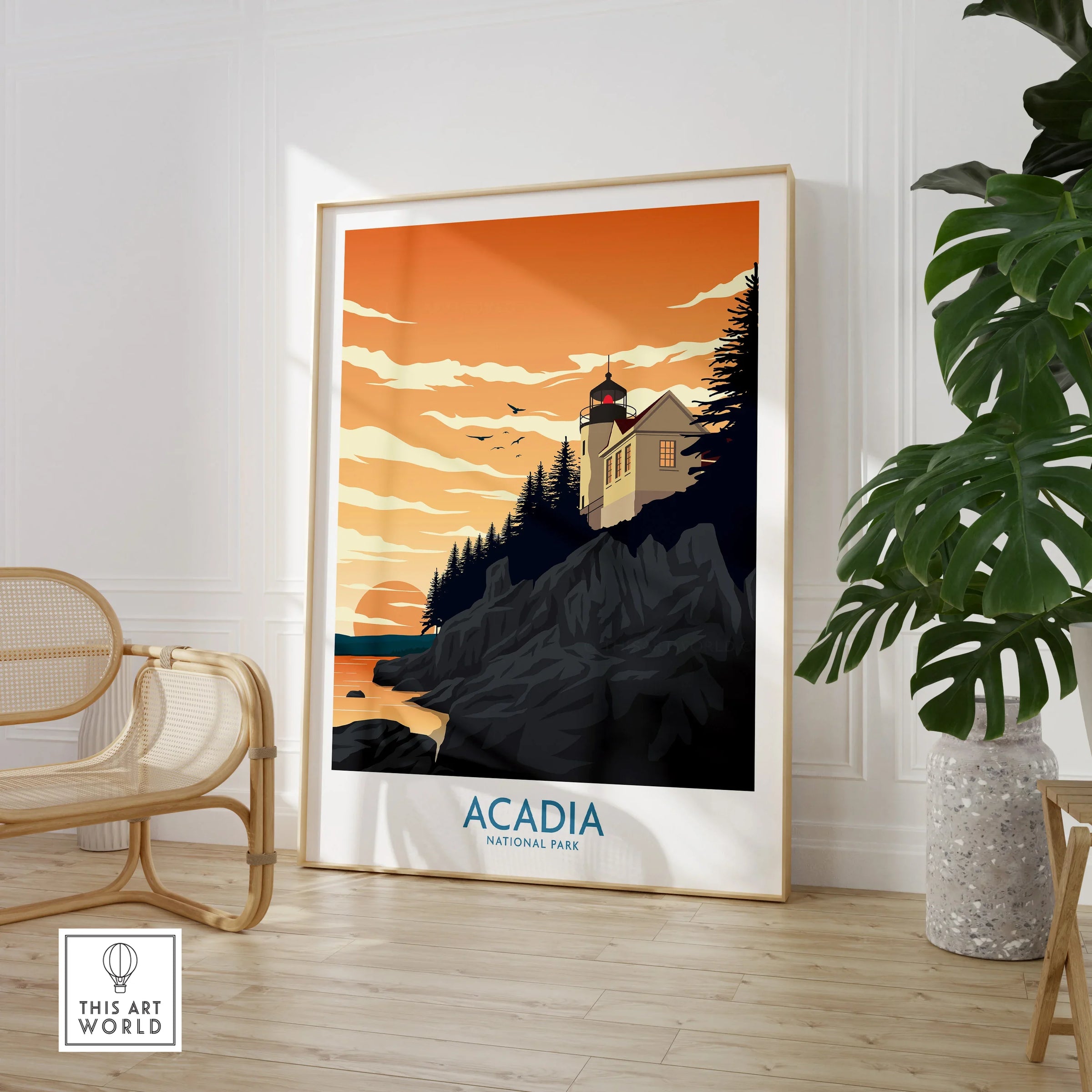 Acadia National Park framed art print with lighthouse, sunset sky, in modern room with chair and plant