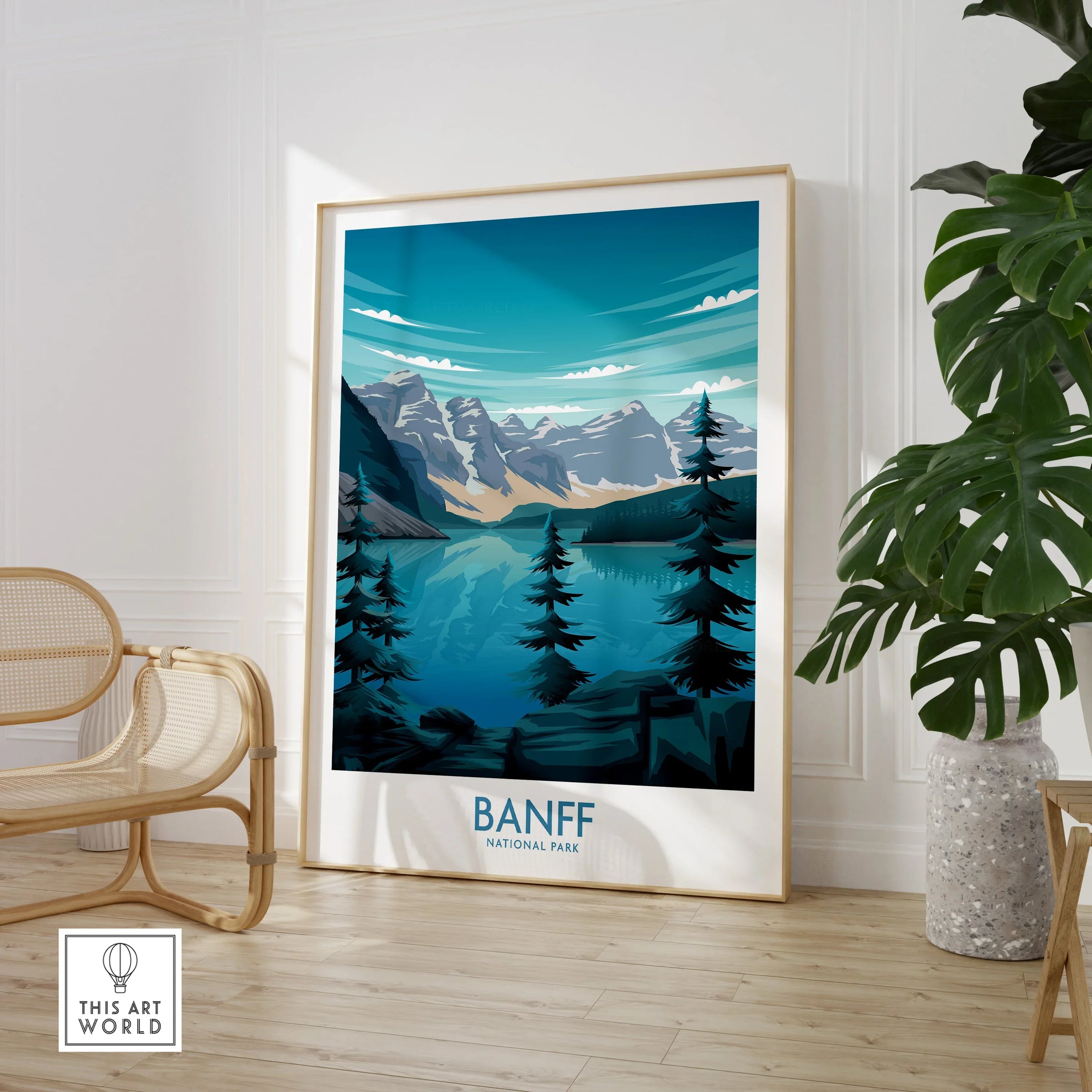 Framed Banff National Park art print in modern room with chair and green plant