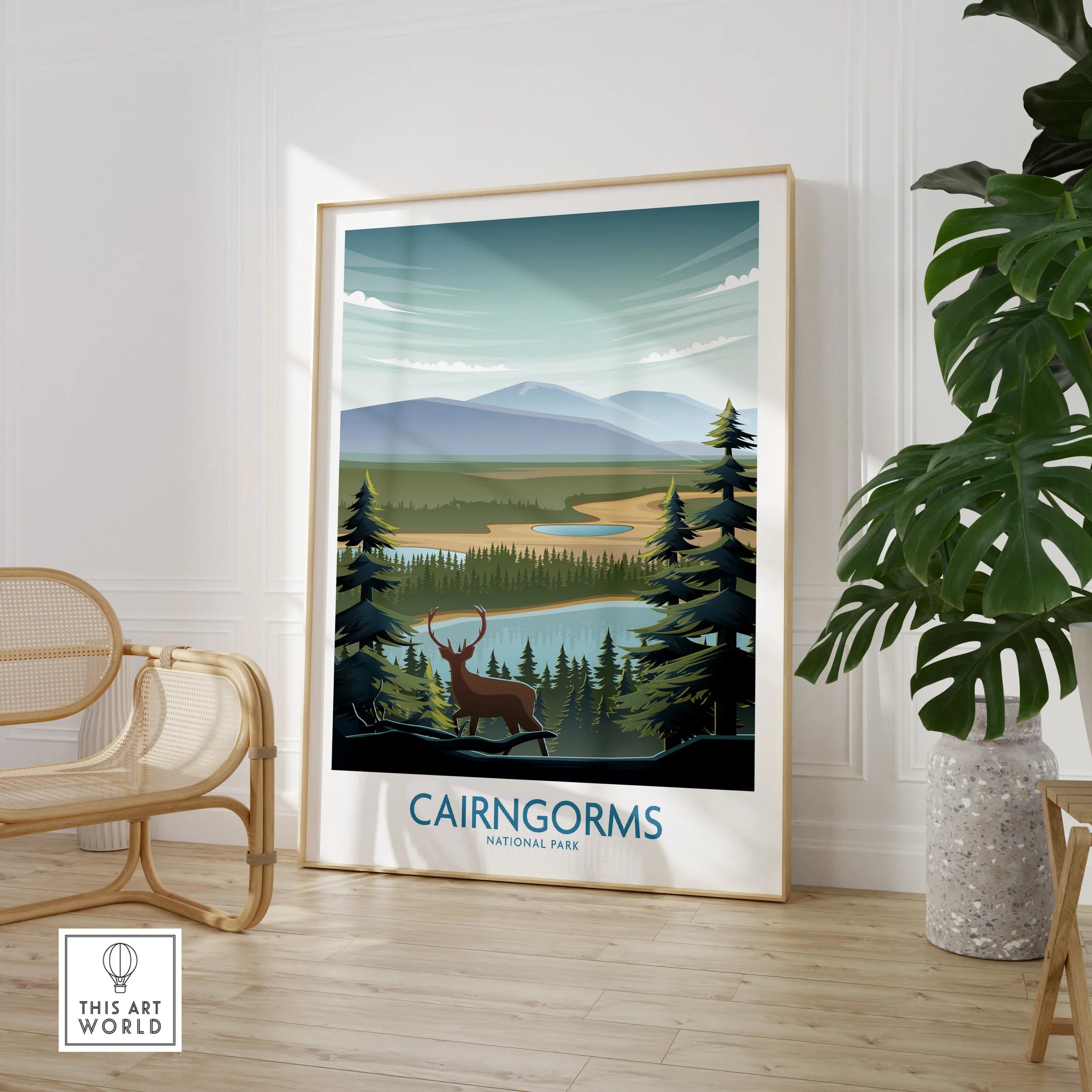 Framed Cairngorms National Park travel poster with deer, in modern room with chair and plant