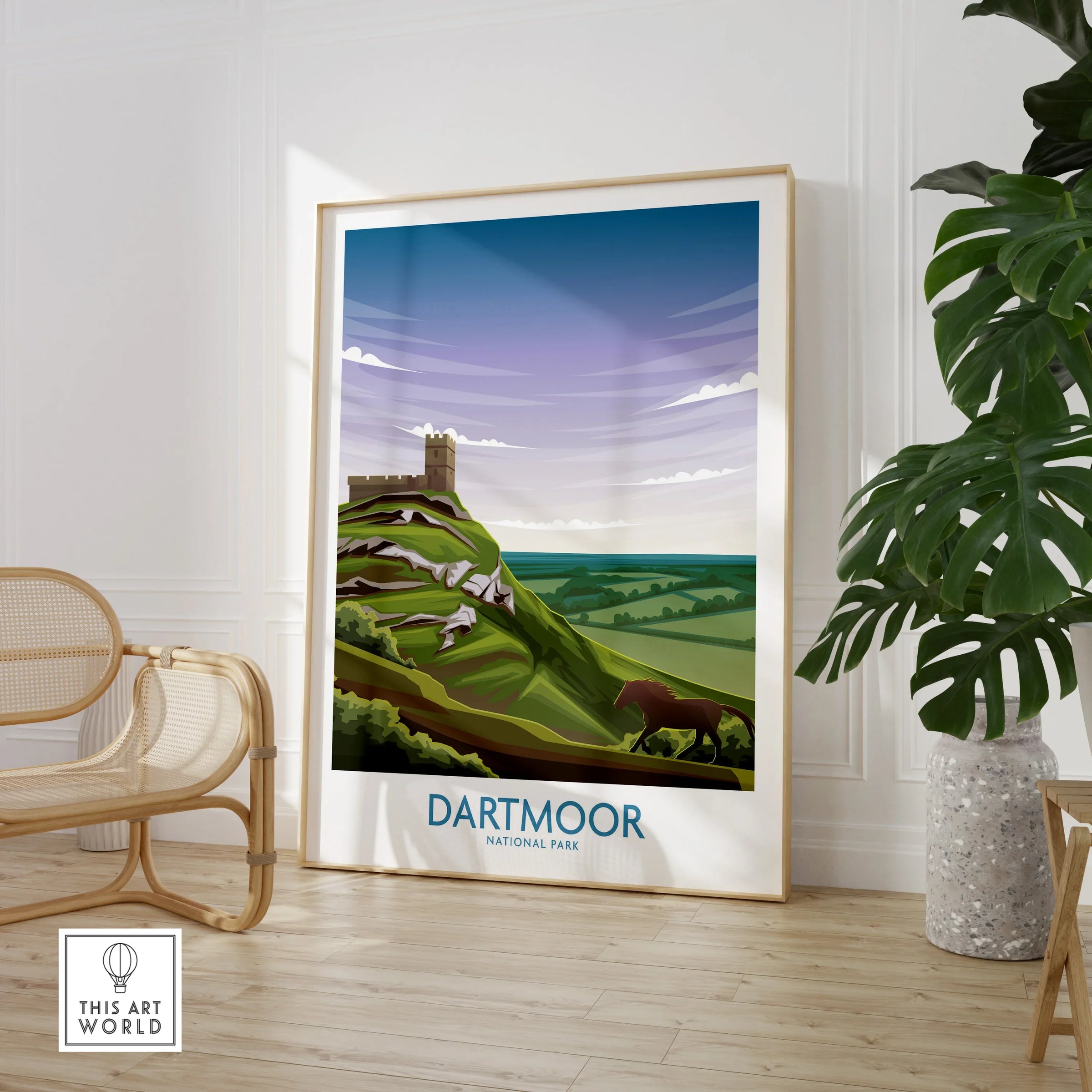Dartmoor National Park travel poster in modern room with rattan chair and potted plant.